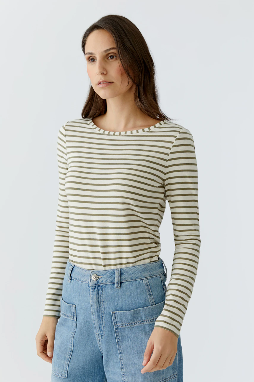 Casual long-sleeve shirt: Woman in a striped pullover paired with relaxed-fit jeans.
