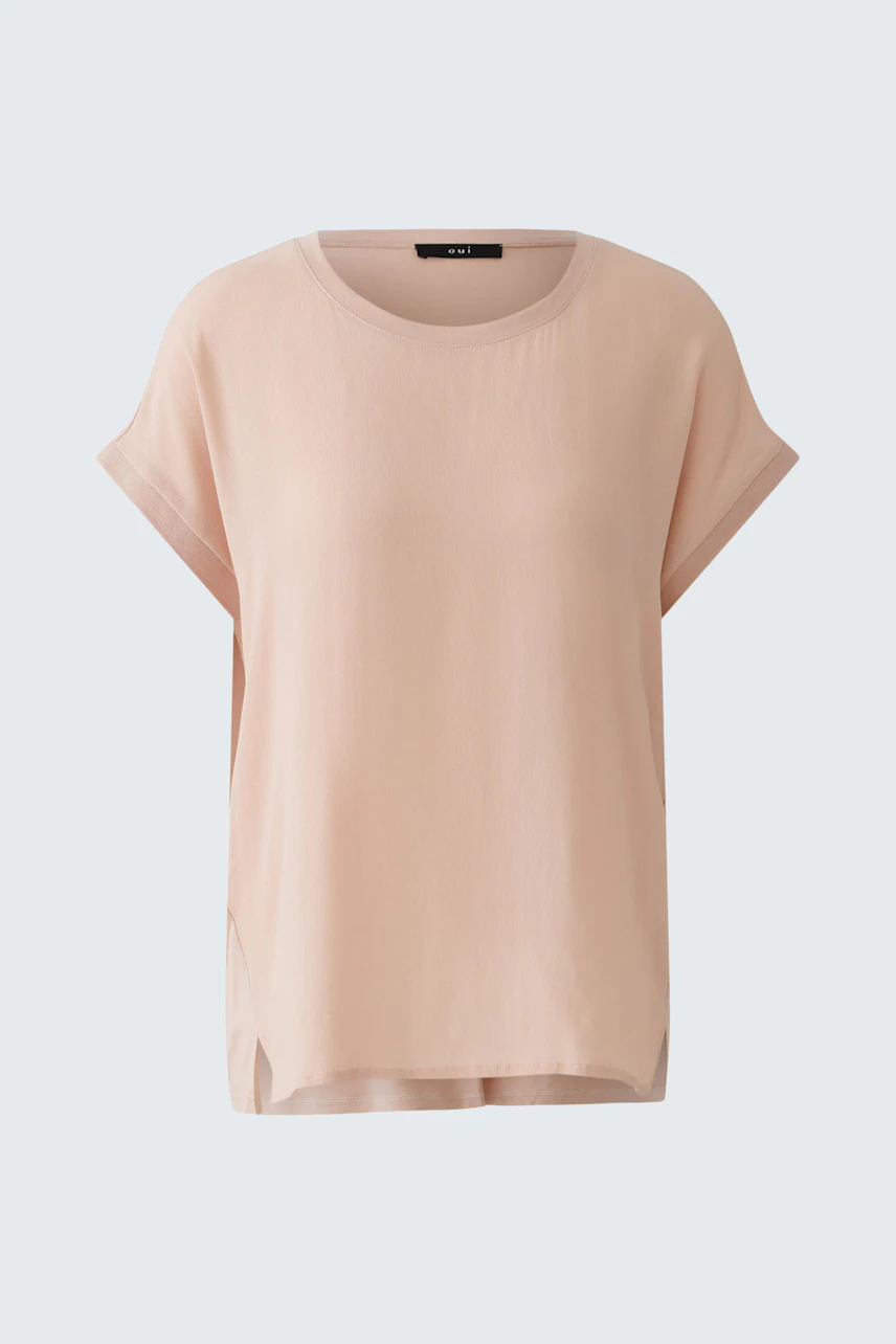 Casual women's blouse shirt in soft pink with short sleeves and a relaxed fit.