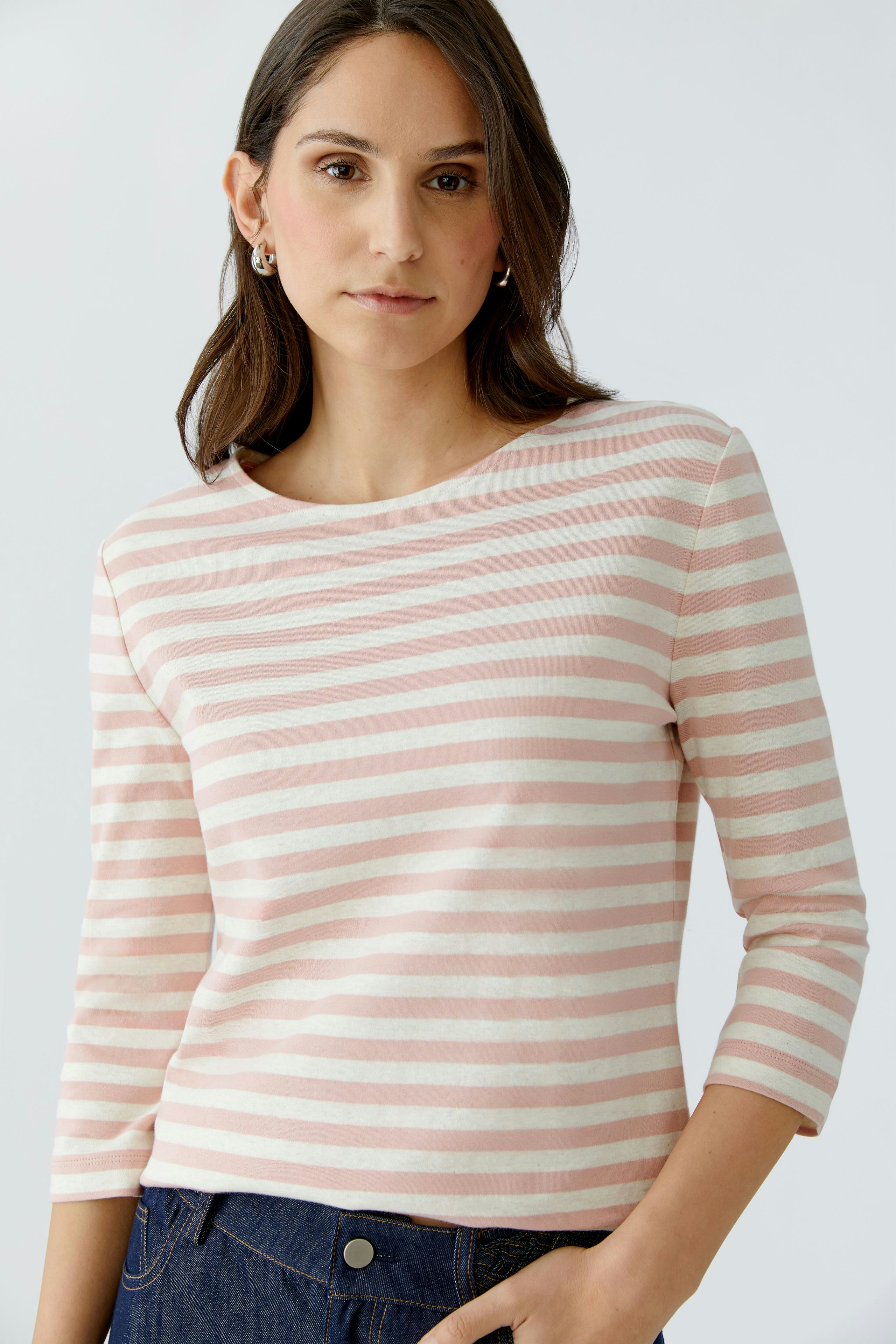 Casual women's T-shirt: Young woman in a pink and white striped top with three-quarter sleeves.