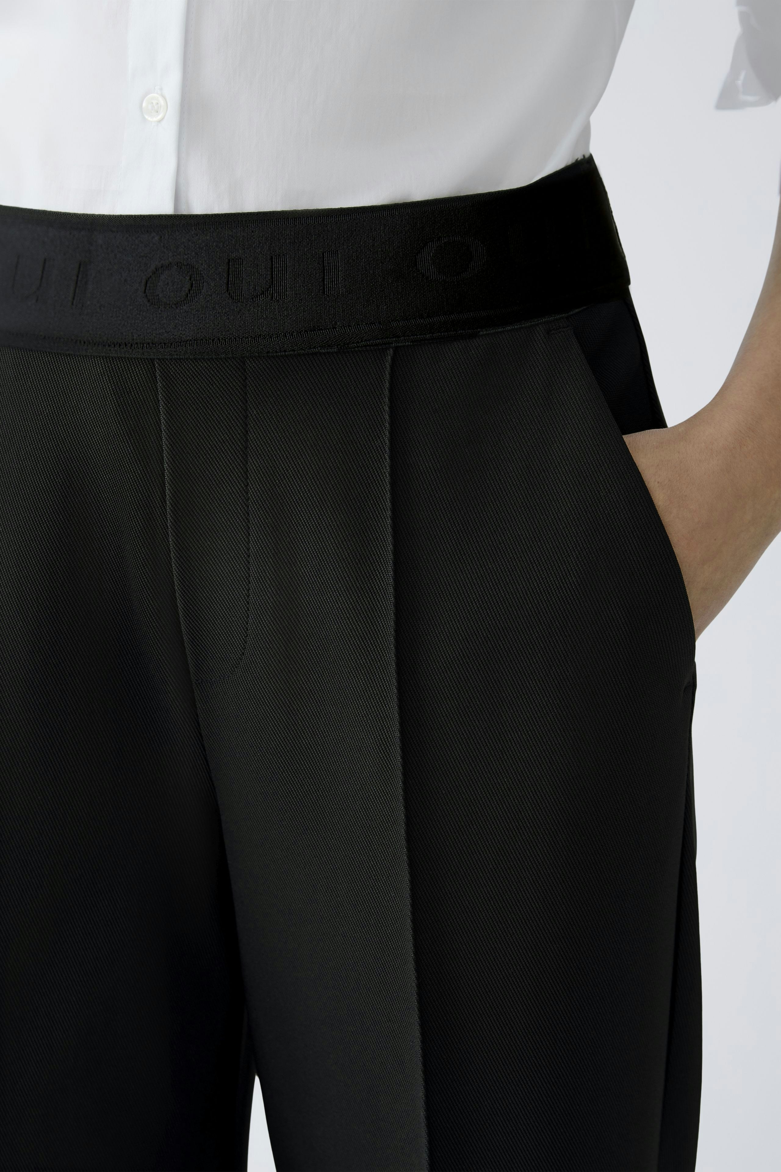 Modern culotte: Close-up of a woman wearing black culottes with a comfortable waistband.