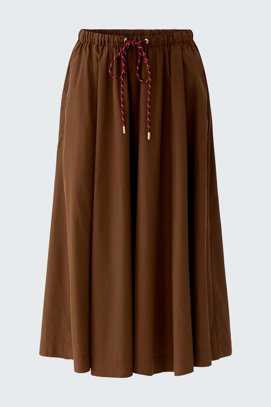Casual A-line skirt: A woman in a brown A-line skirt with a drawstring waist, perfect for everyday wear.