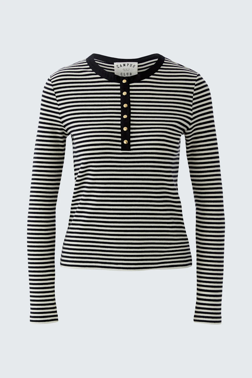 Casual long-sleeve shirt: A woman in a black and white striped pullover with button details.