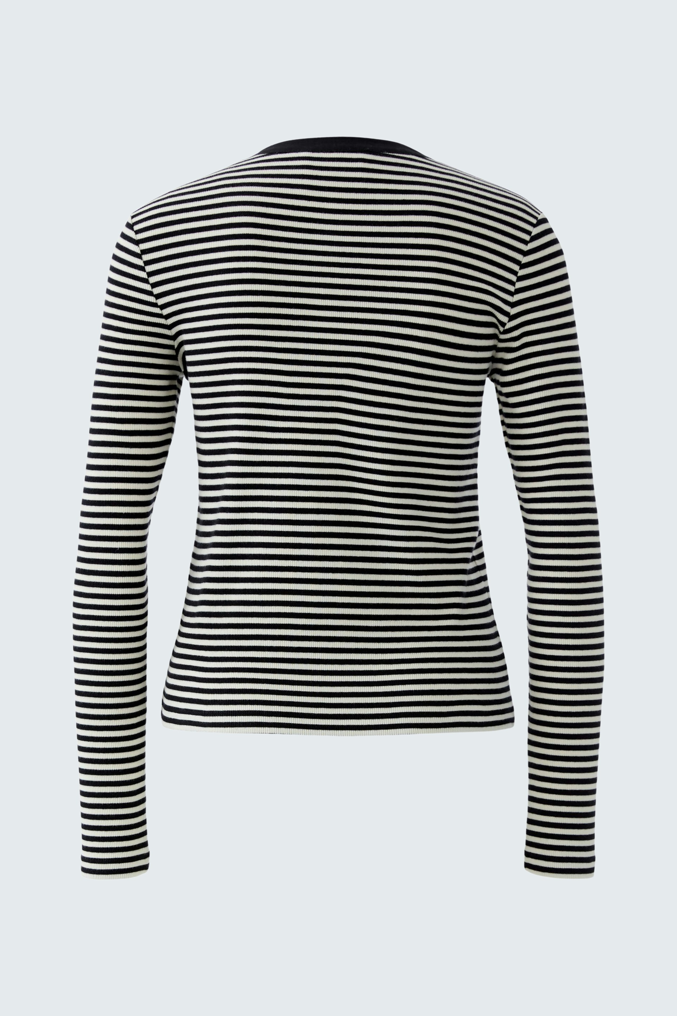 Casual long-sleeve shirt: A woman in a black and white striped pullover, showcasing a relaxed style.
