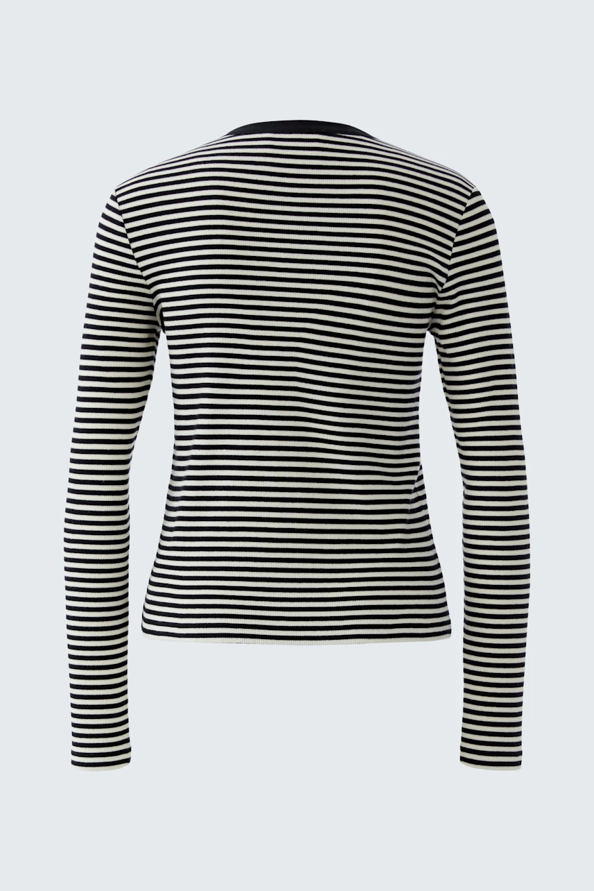 Casual long-sleeve shirt: A woman in a black and white striped pullover, showcasing a relaxed style.