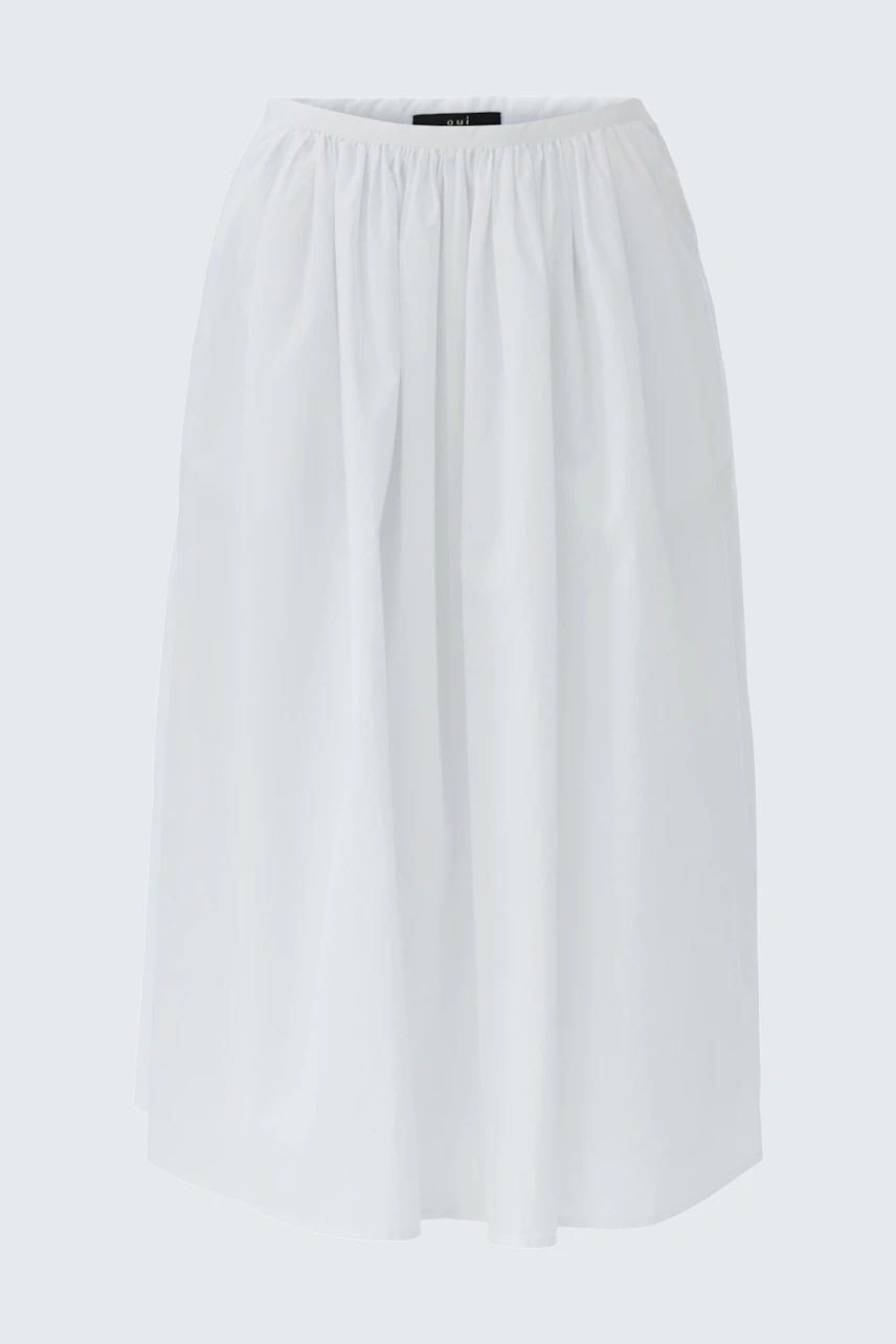 Casual A-line skirt: A woman in a white A-line skirt with a relaxed fit, perfect for everyday wear.