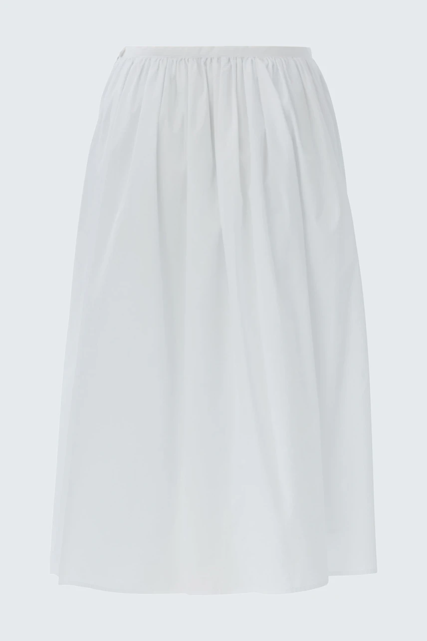 Casual A-line skirt: A woman in a white A-line skirt with gathered waist, perfect for everyday wear.