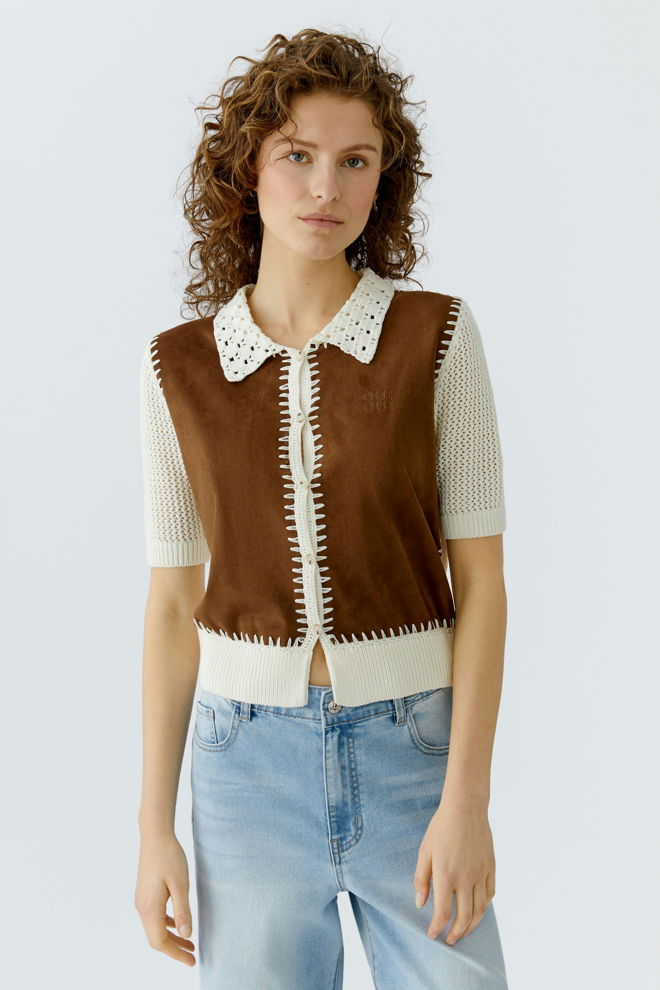 Casual women's cardigan: A woman in a brown and cream cardigan with a collar and short sleeves.