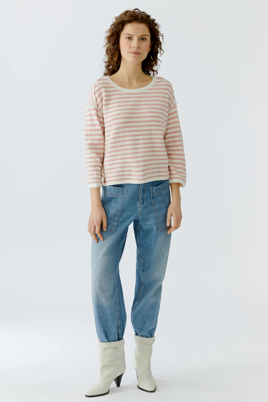 Damen-Pullover: Frau in gestreiftem, lässigem Pullover mit 3/4-Ärmeln und lockeren Jeans.