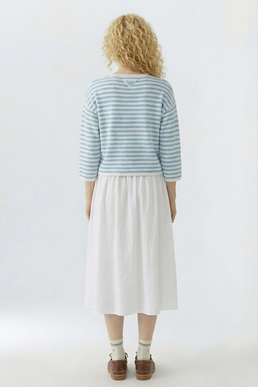 Casual women's pullover: A woman in a striped blue pullover with three-quarter sleeves and a relaxed fit.