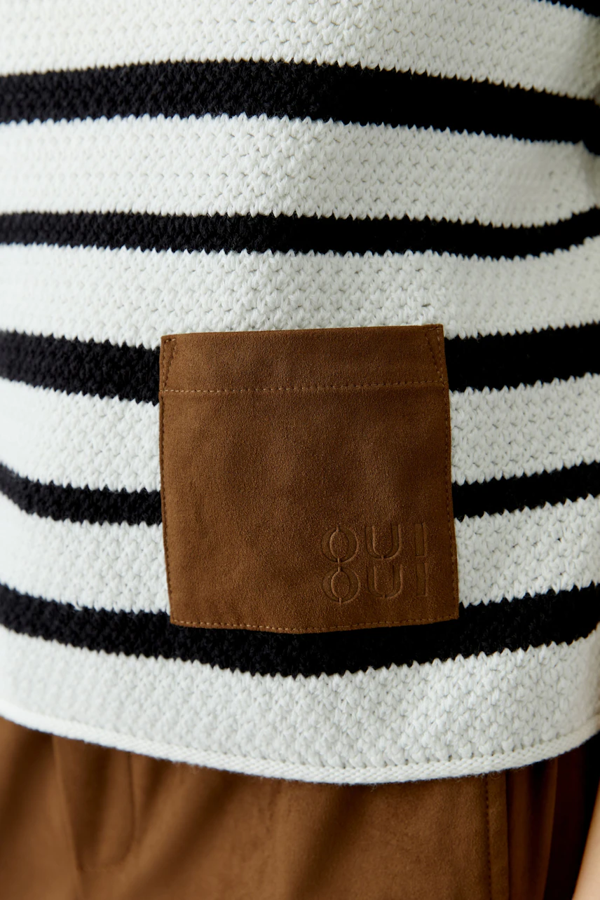 Casual women's pullover: Close-up of a striped pullover with a brown patch, perfect for everyday wear.