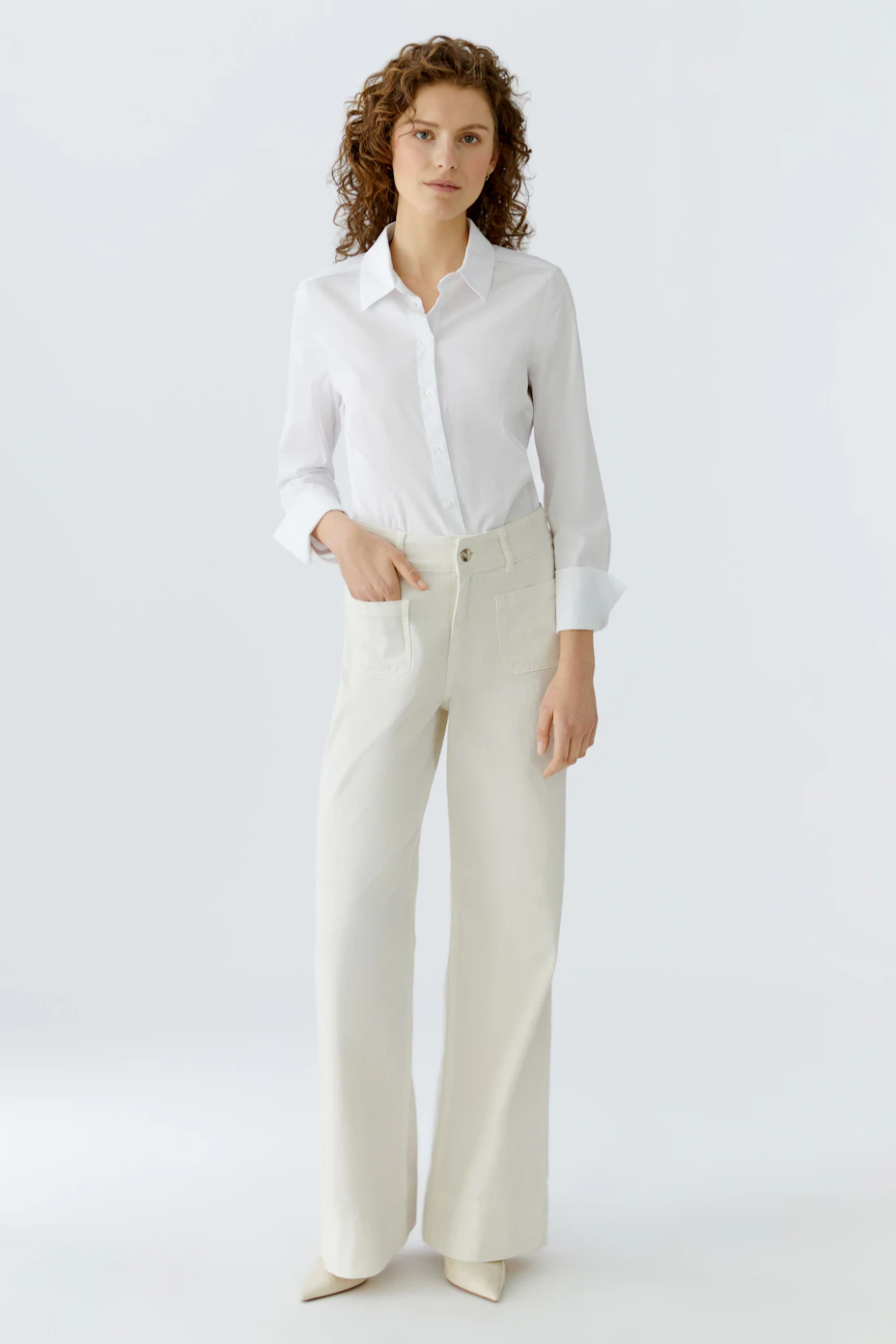 Wide leg jeans for women in a light color, featuring a relaxed fit and classic pockets.