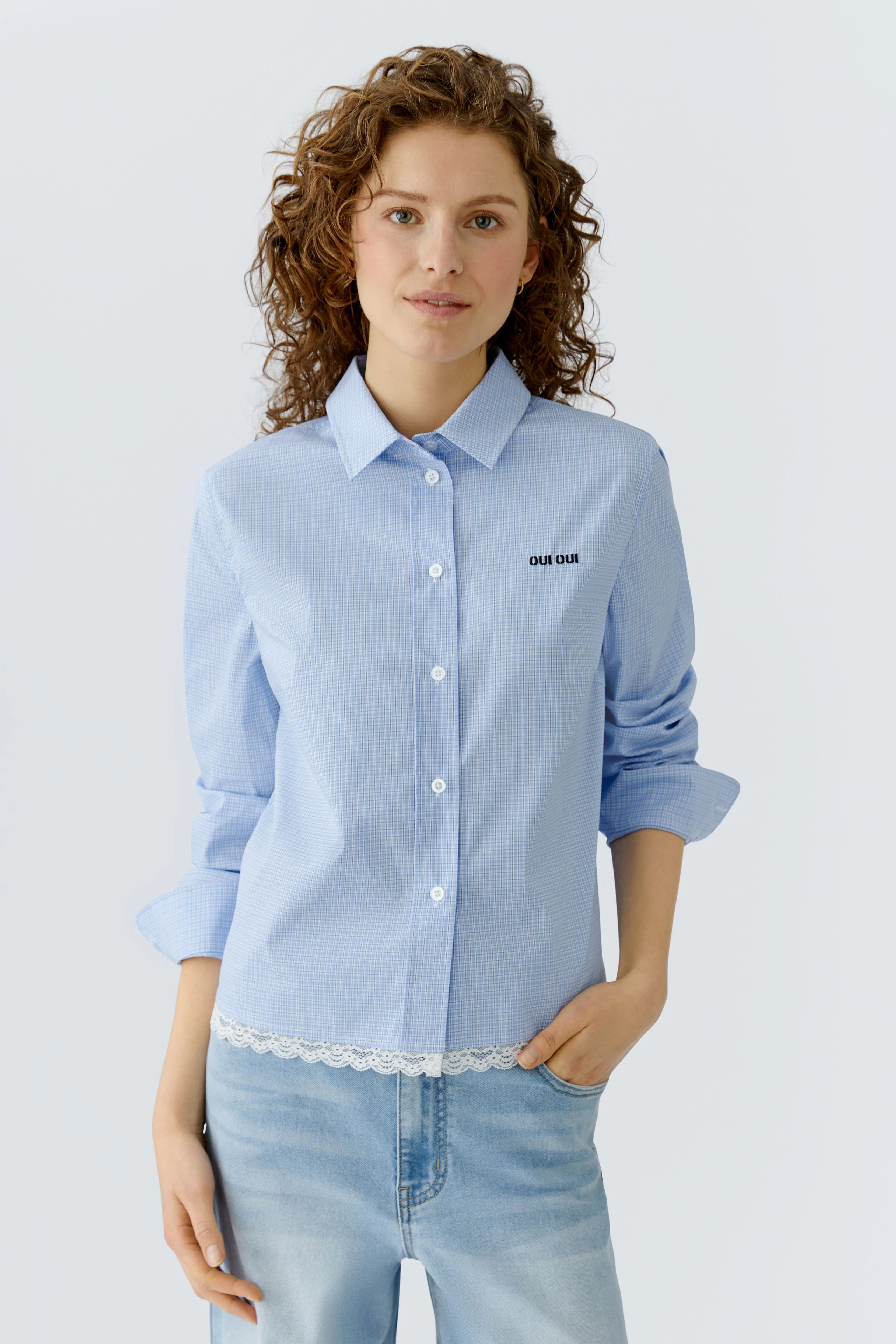 Casual women's shirt blouse: A woman in a light blue checked shirt with lace detail and a relaxed fit.