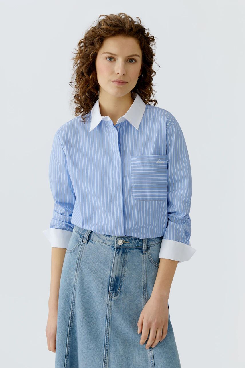Casual women's blouse: A woman in a blue striped blouse with a white collar and a pocket.