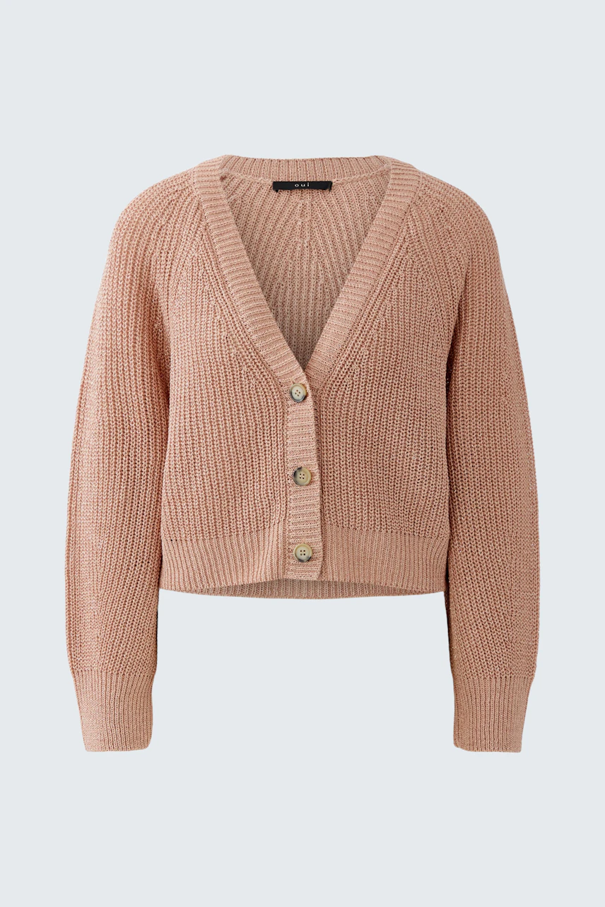 Casual women's cardigan: A woman in a soft pink knitted cardigan with a V-neck and button closure.