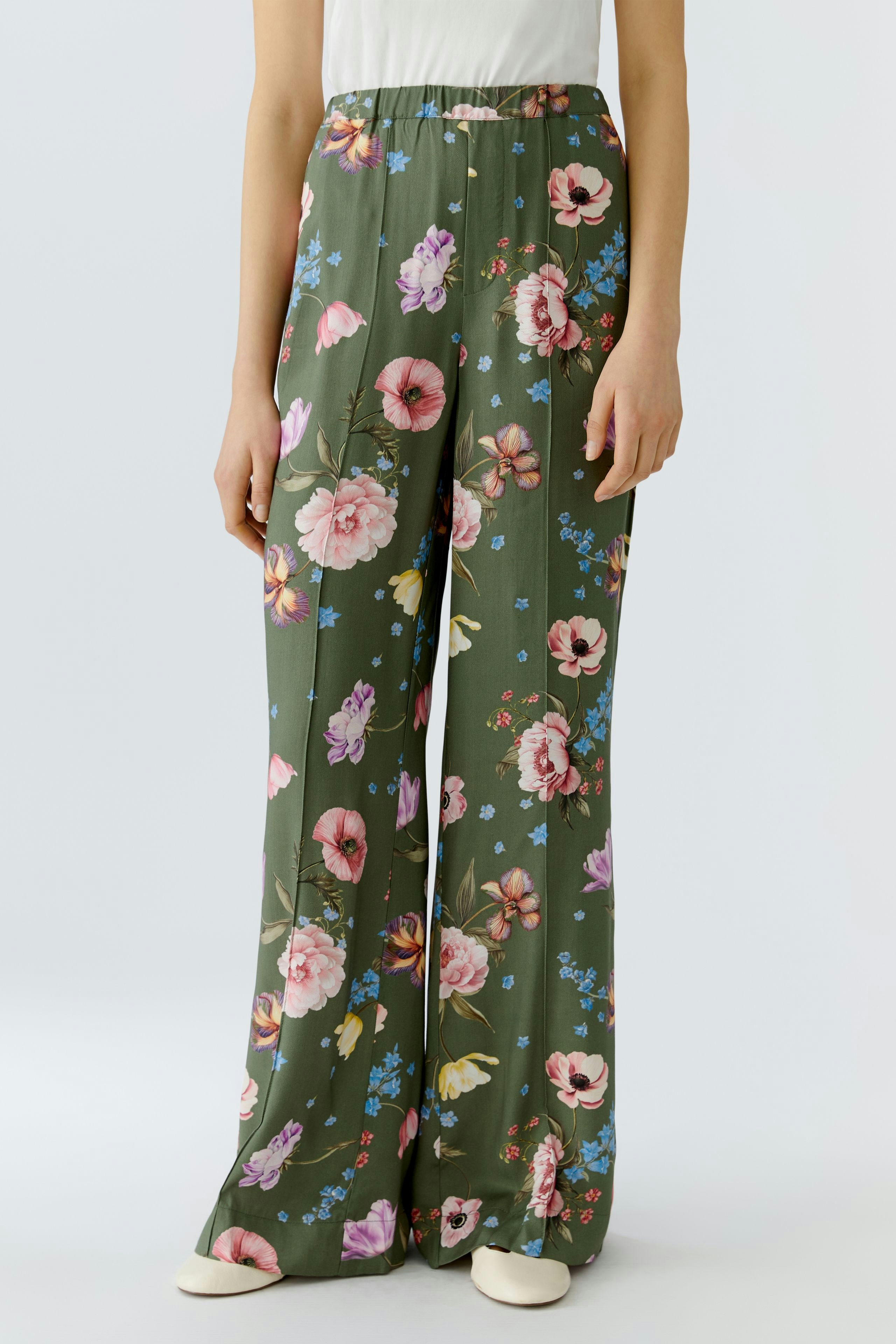 Floral wide-leg pants for women in green with pink and blue flowers.