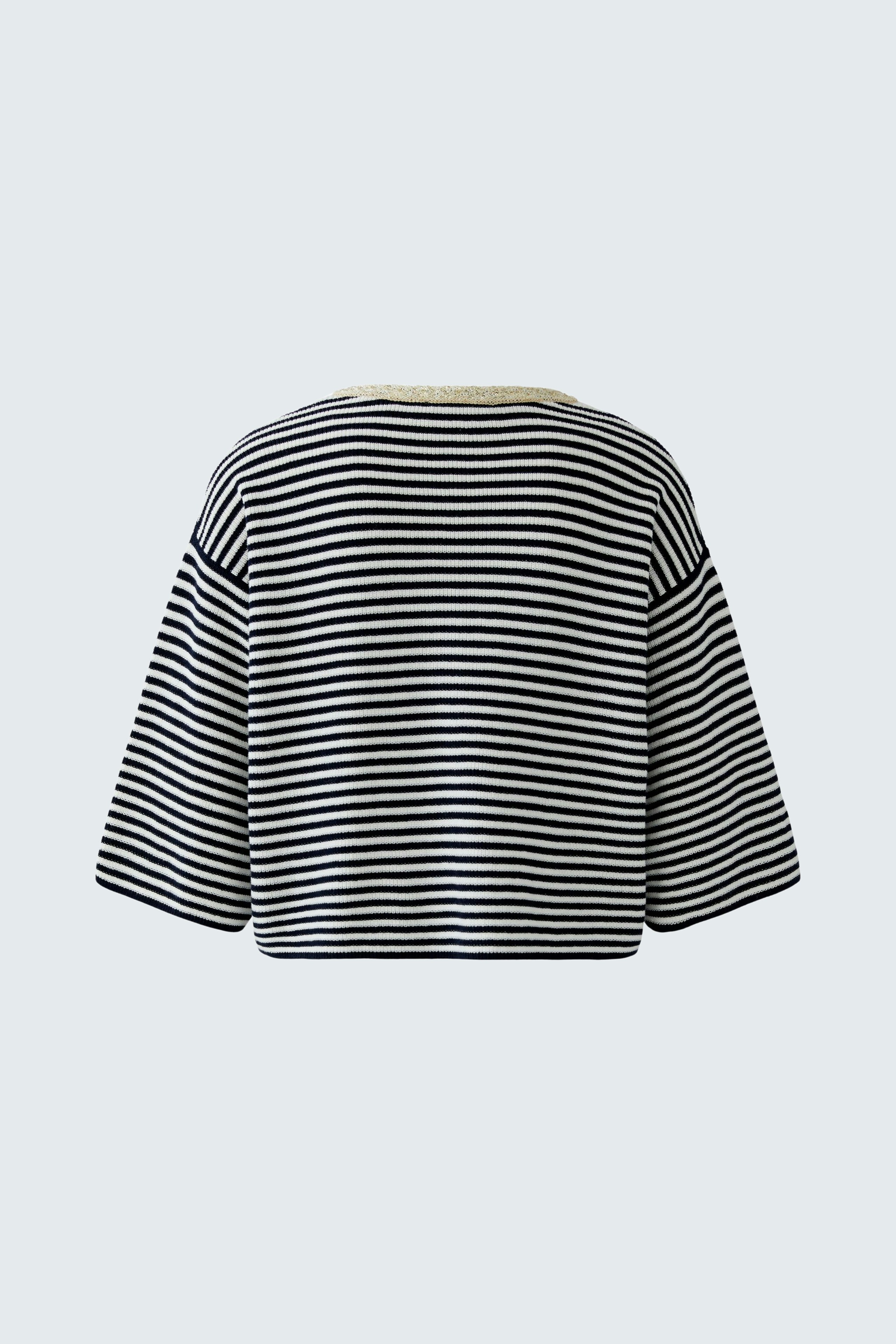 Casual women's cardigan: A woman in a striped pullover with wide sleeves, showcasing a relaxed style.