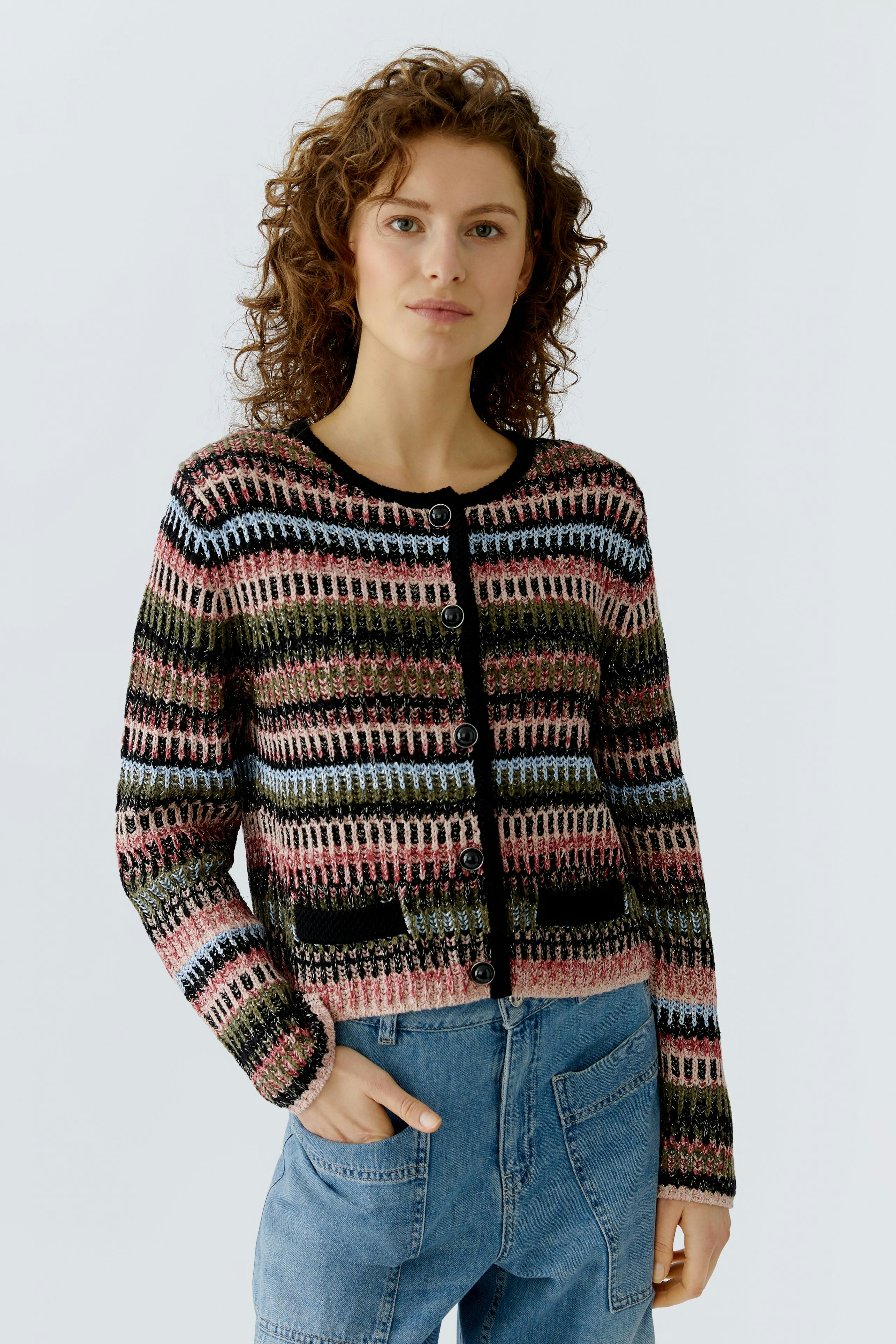 Casual women's cardigan: A woman in a colorful knitted cardigan with buttons and relaxed fit.