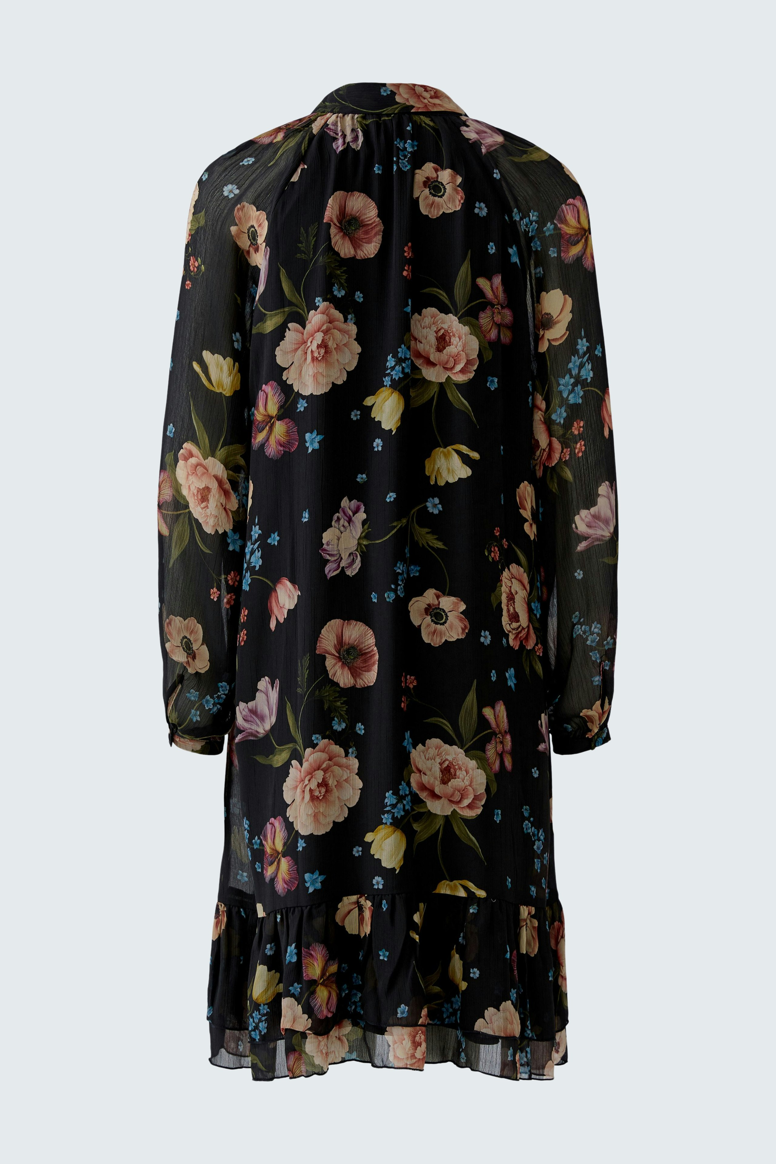 A-line dress: A woman in a floral dress with long sleeves and a ruffled hem, showcasing a vibrant design.