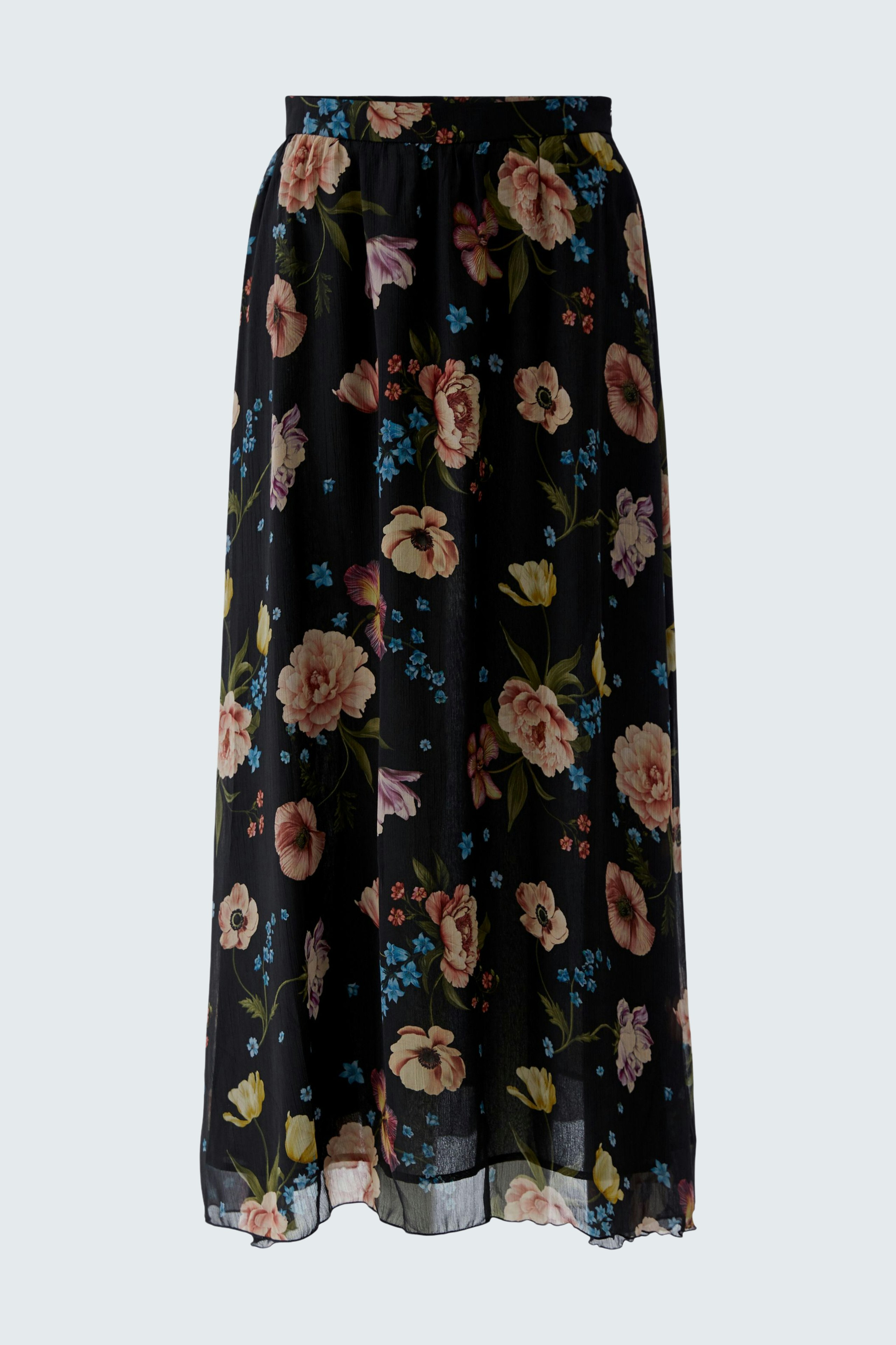 Floral maxi skirt: A woman wearing a flowy black skirt adorned with colorful flowers.