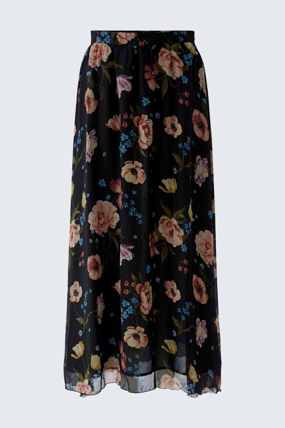Floral maxi skirt: A woman wearing a flowy black skirt adorned with colorful flowers.