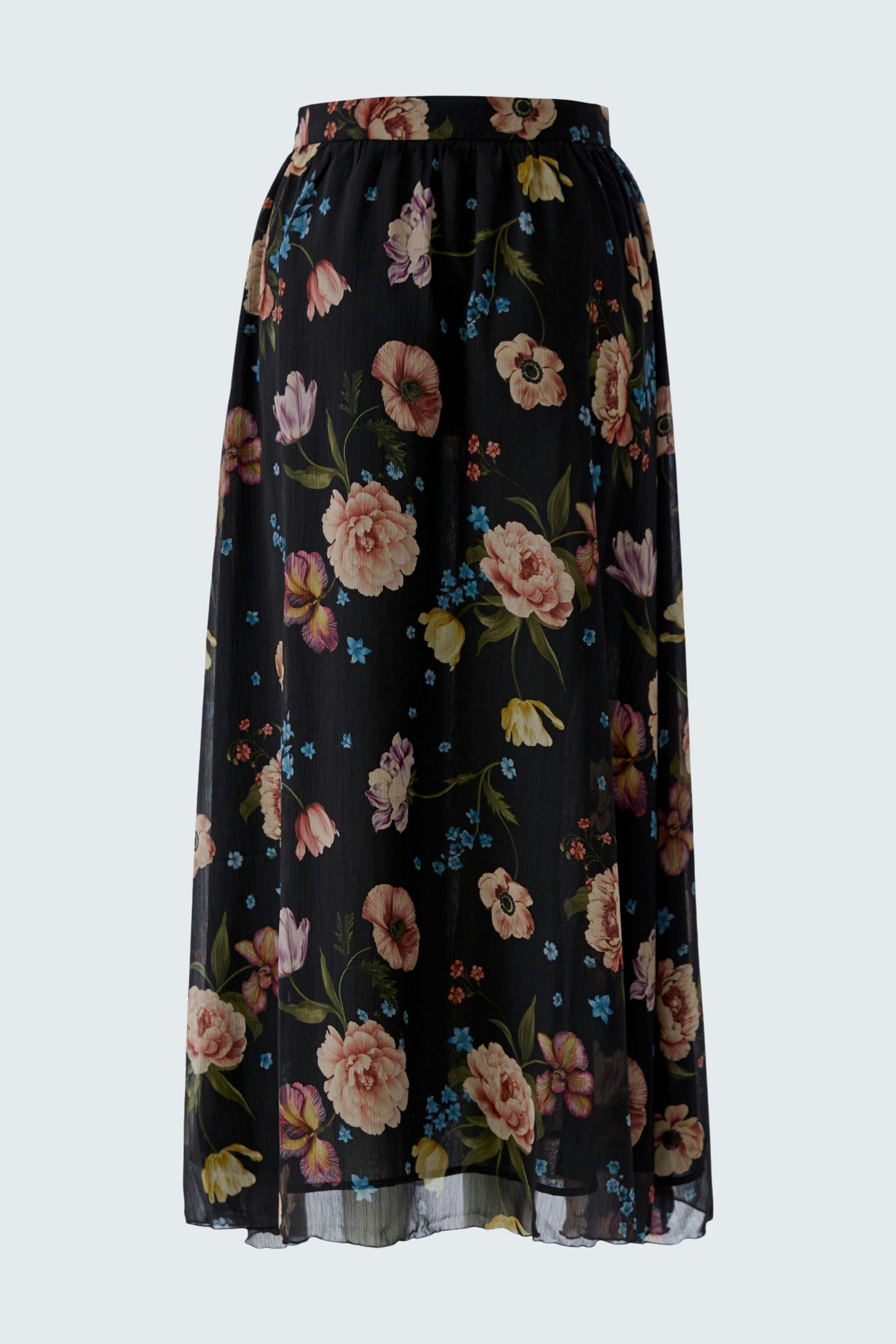 Floral maxi skirt: A woman in a flowy black skirt with colorful flowers, perfect for casual outings.