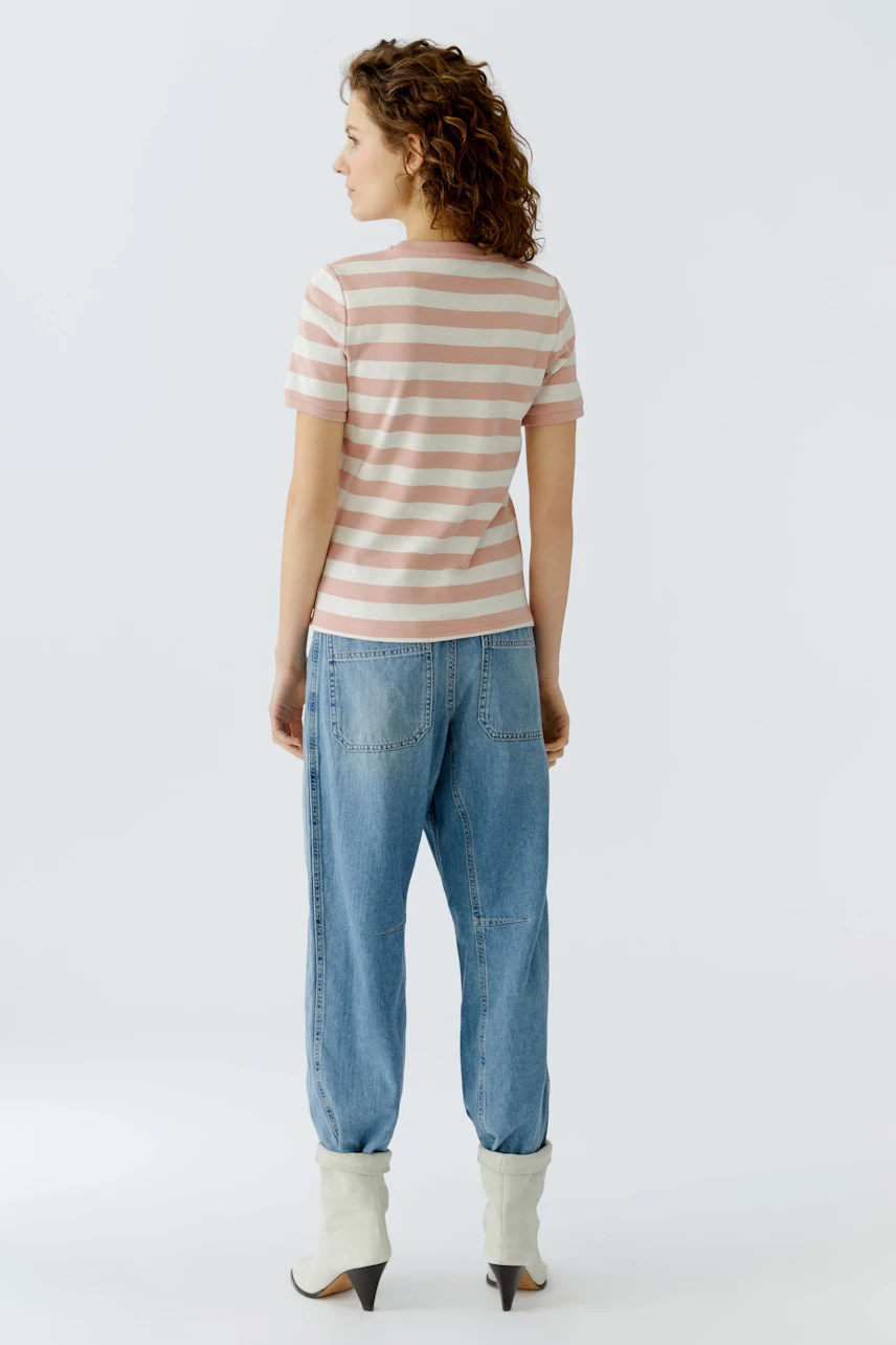 Casual women's T-shirt: A woman in a striped tee with short sleeves and relaxed fit jeans.