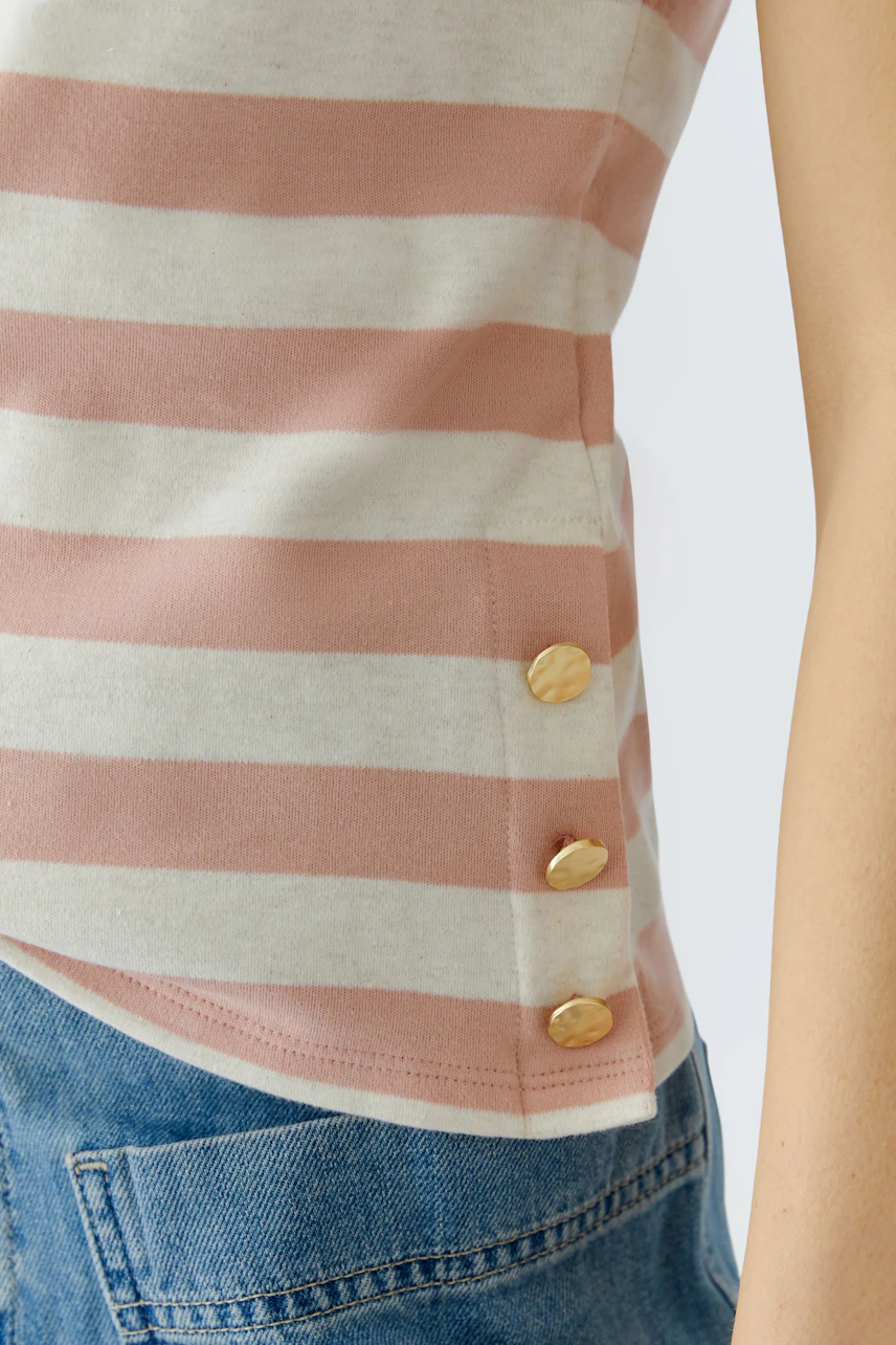Casual women's T-shirt: Close-up of a woman in a striped top with button details.