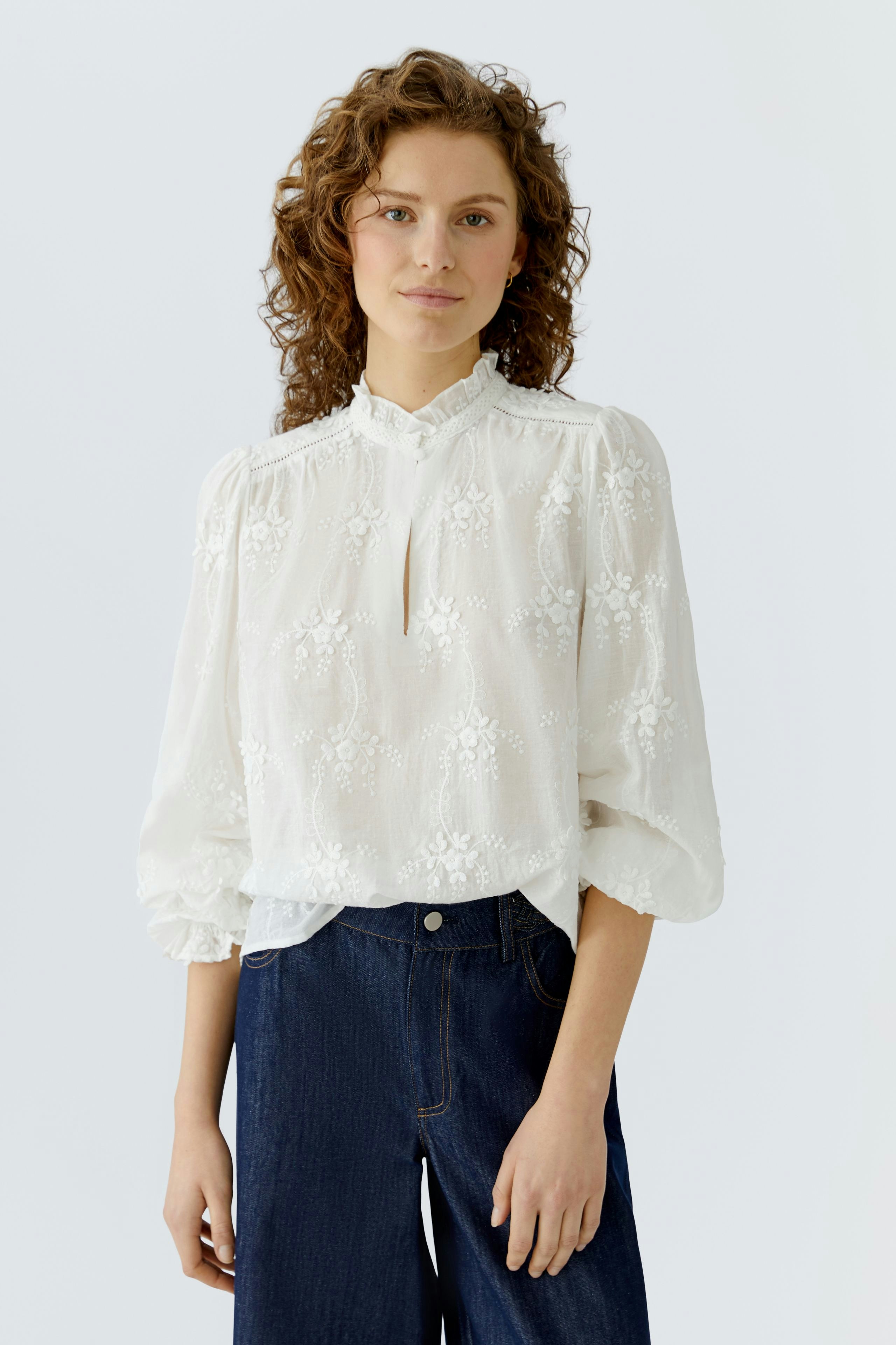 Lightweight women's blouse with floral embroidery, featuring a keyhole neckline and puffed sleeves.