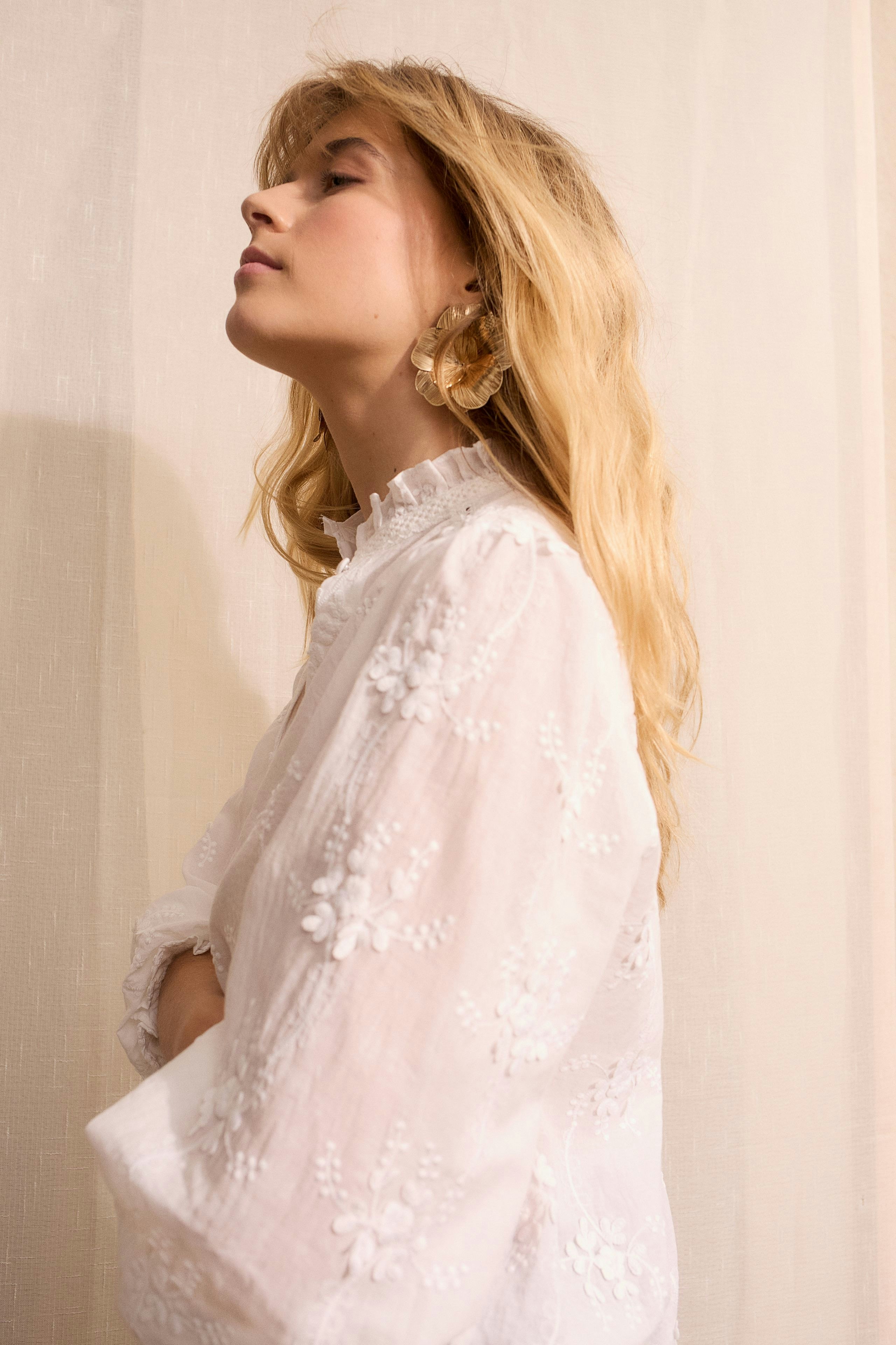 Lightweight women's blouse with floral embroidery, featuring a relaxed fit and soft fabric.