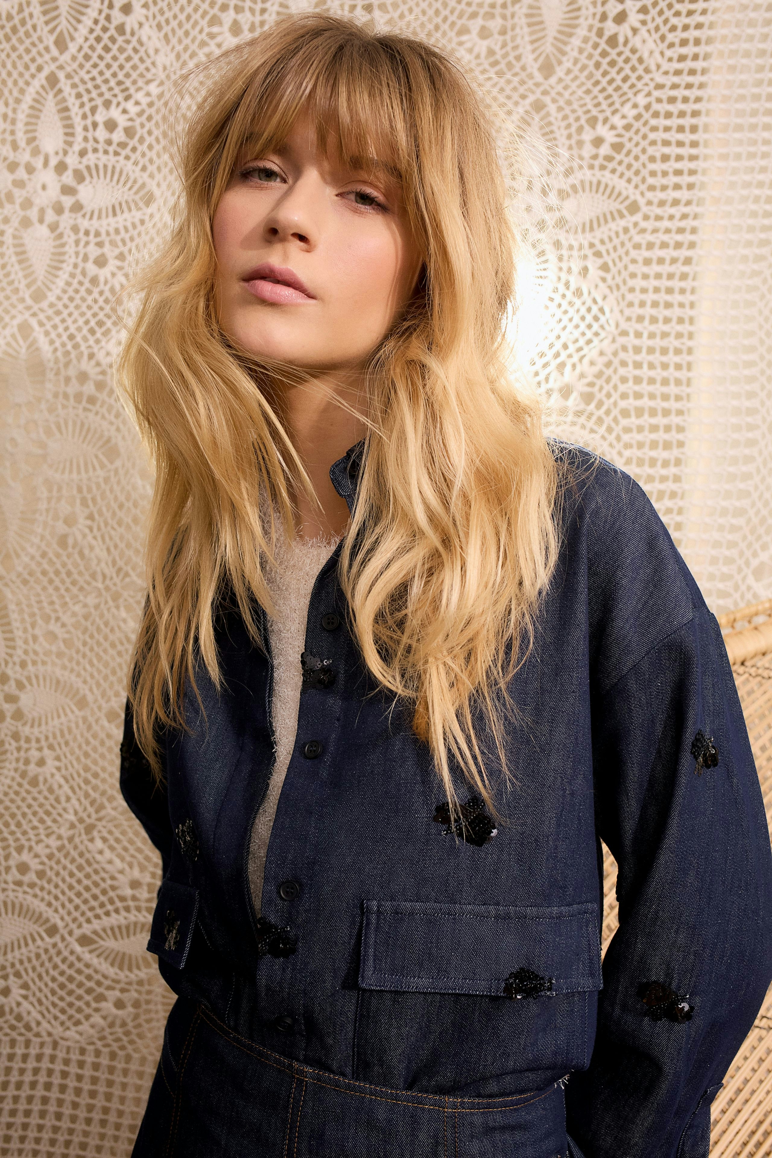 Casual women's jacket: A woman in a denim jacket with unique embellishments, exuding a relaxed vibe.