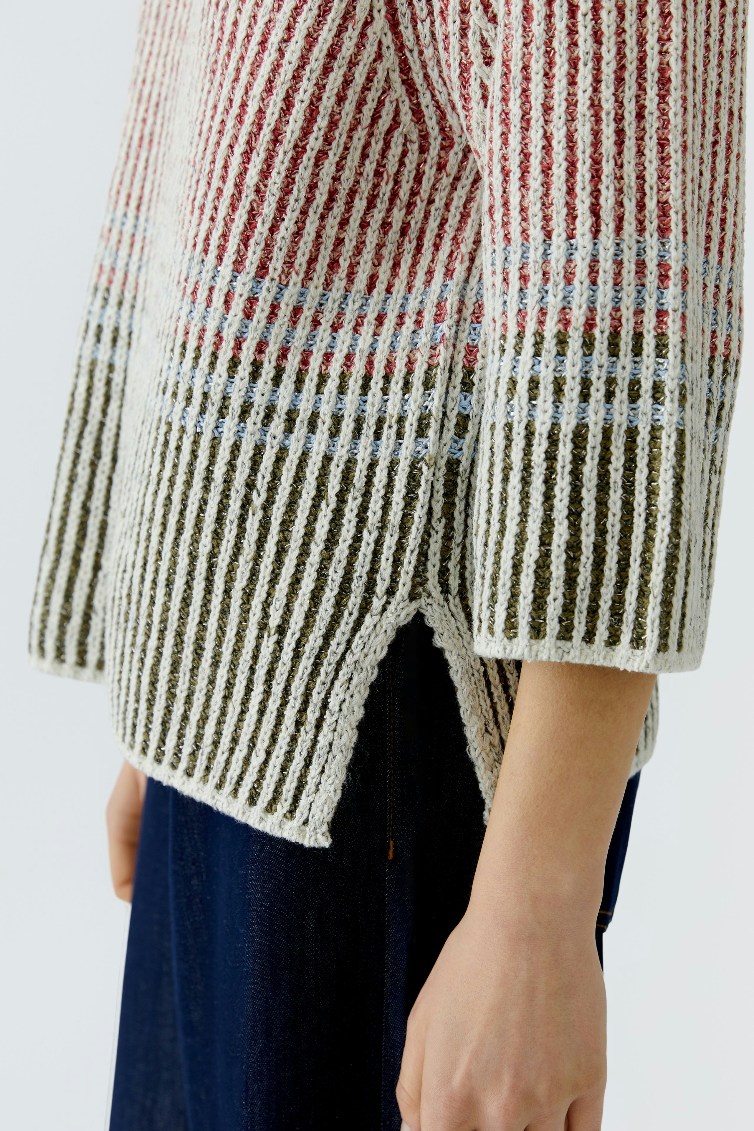 Casual women's pullover: A woman in a striped pullover with a relaxed fit and side slits.