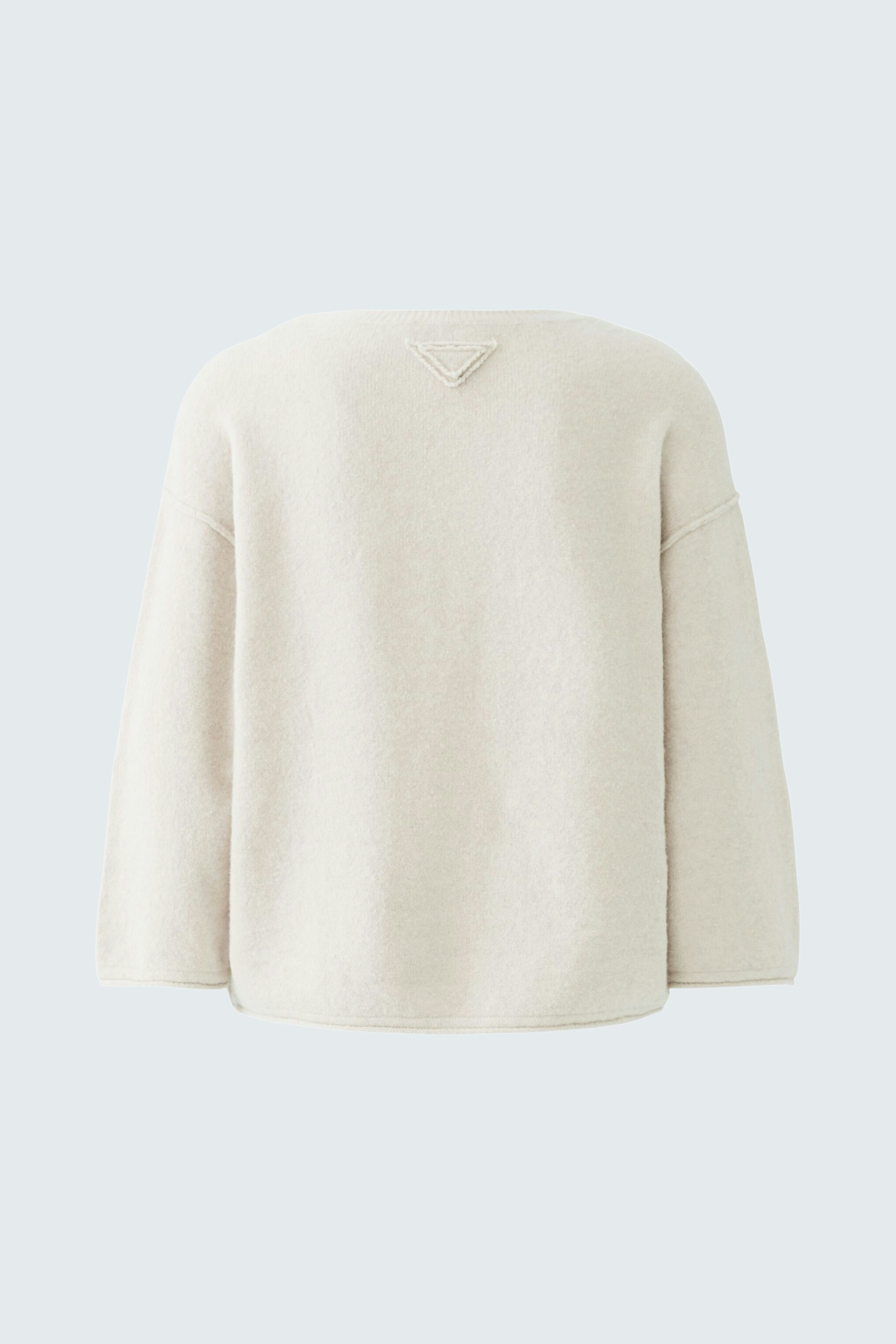Casual women's pullover in soft cream color, featuring a relaxed fit and a simple back design.
