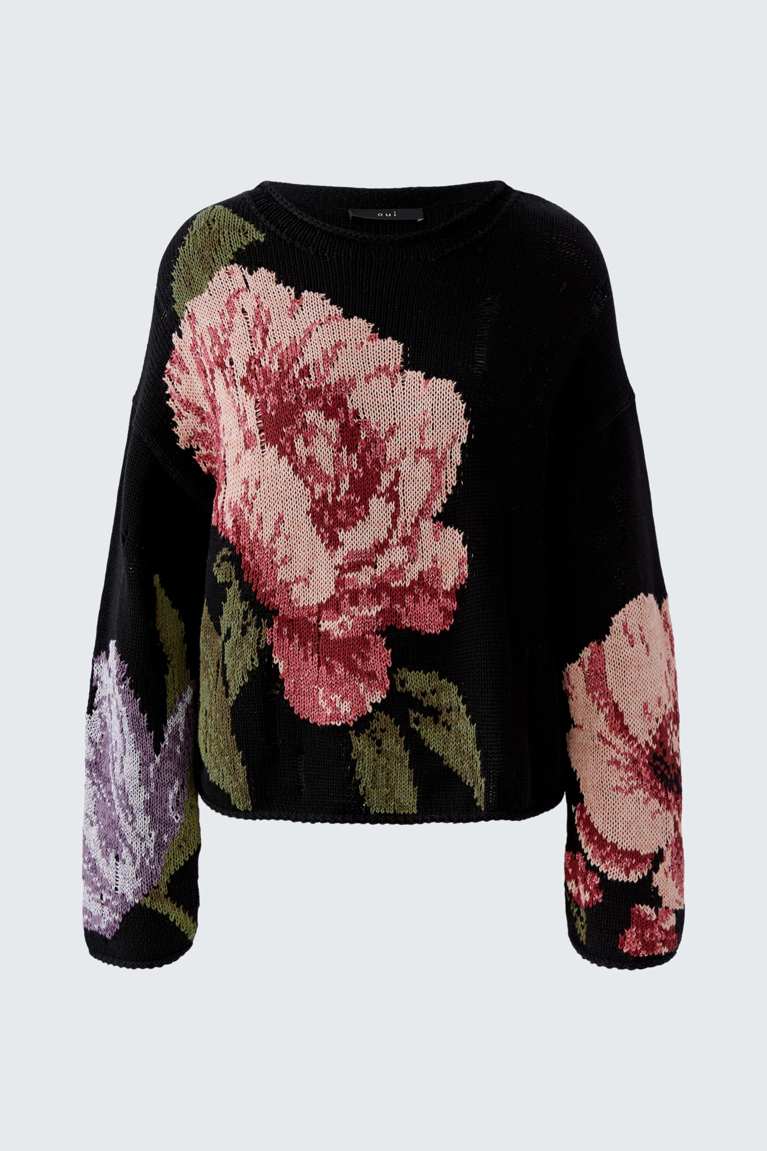 Cozy pullover featuring large floral patterns in pink and purple on a black background.