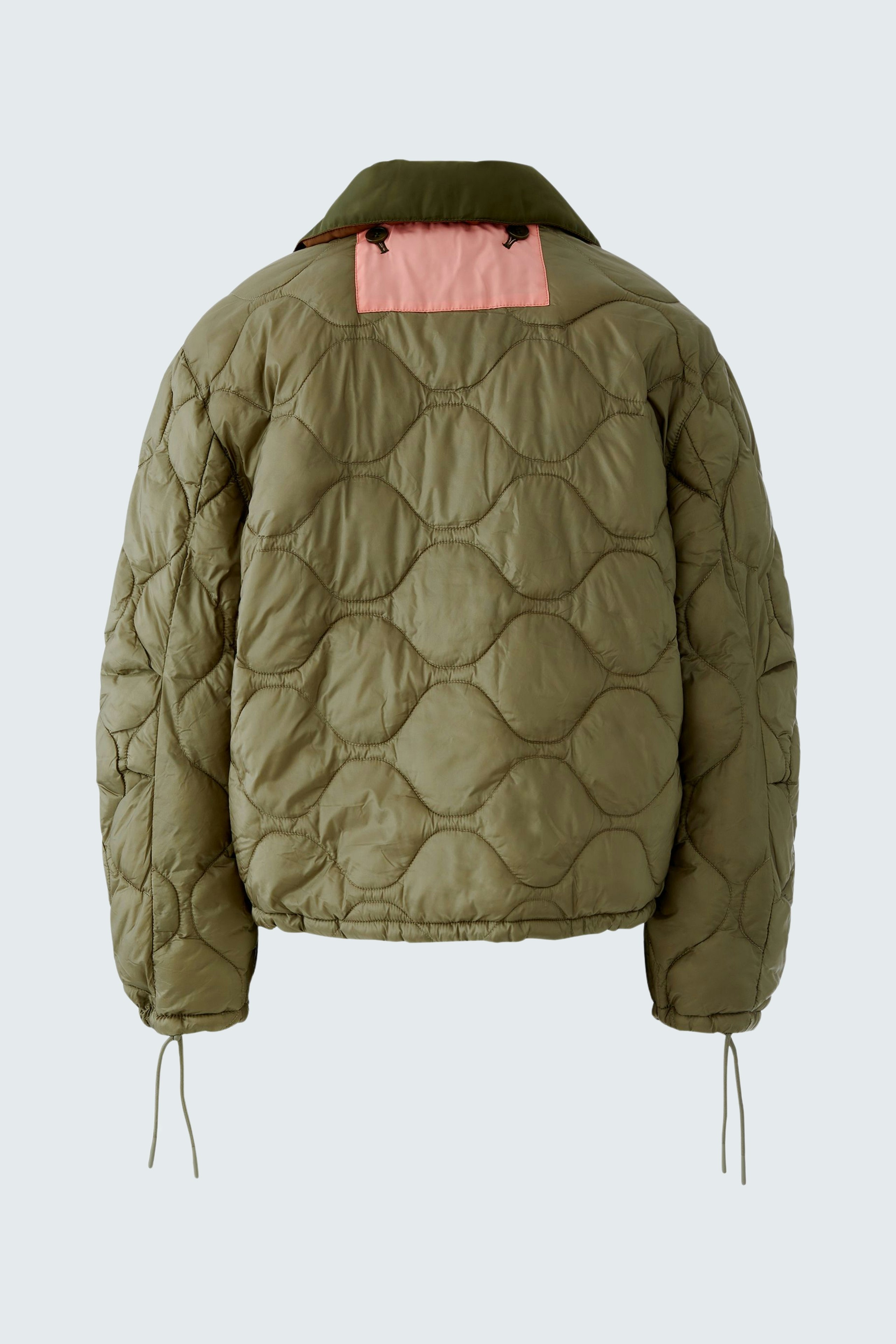 Reversible jacket: Women's olive green quilted jacket with pink details, perfect for versatile styling.