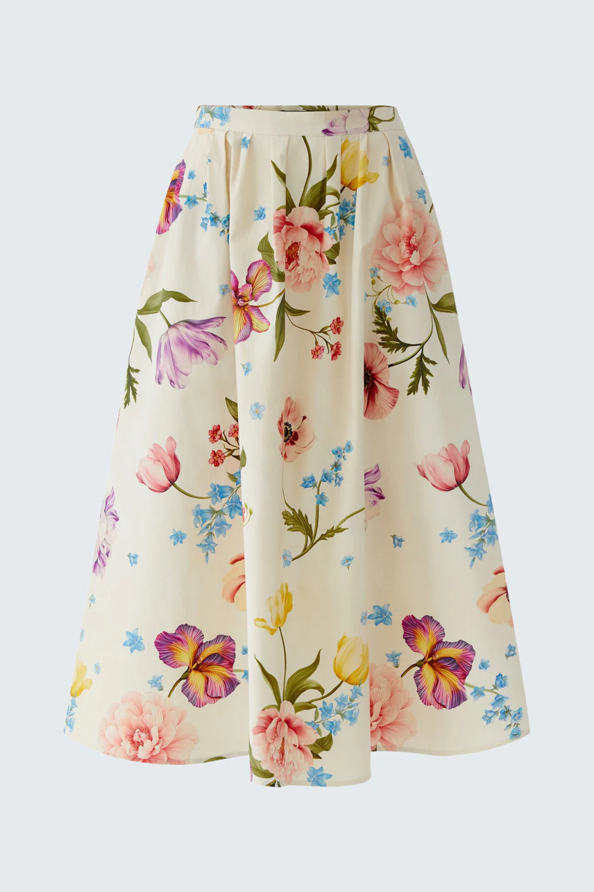 Floral midirock: A woman in a flowy skirt with colorful flowers, perfect for casual outings.