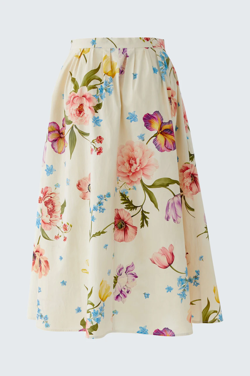 Floral midirock: A woman in a flowy skirt with colorful flowers, perfect for casual outings.