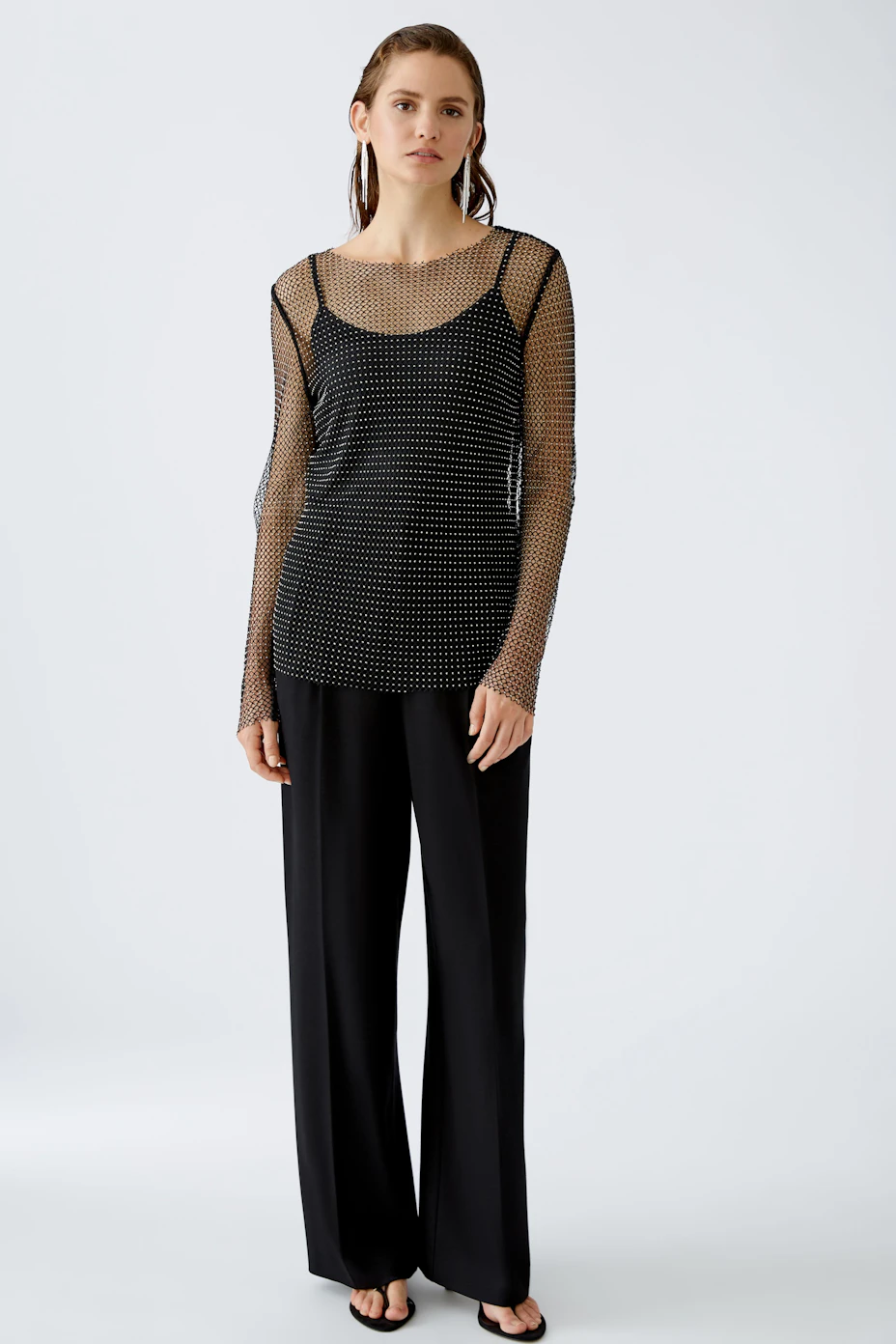 Stylish long-sleeve shirt: A black mesh pullover with dotted pattern, perfect for layering.