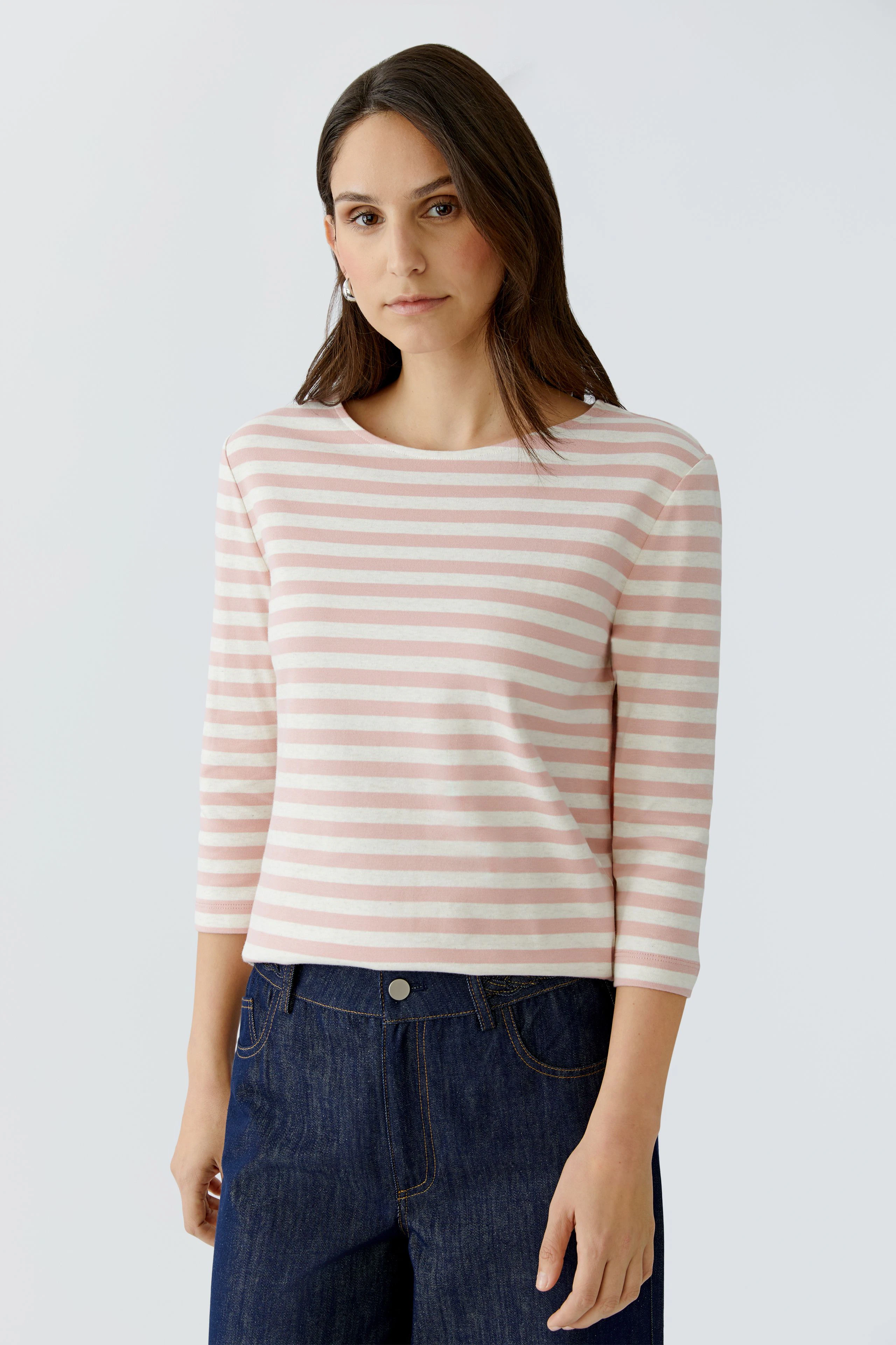 Casual women's T-shirt: Young woman in a pink and white striped top with three-quarter sleeves.