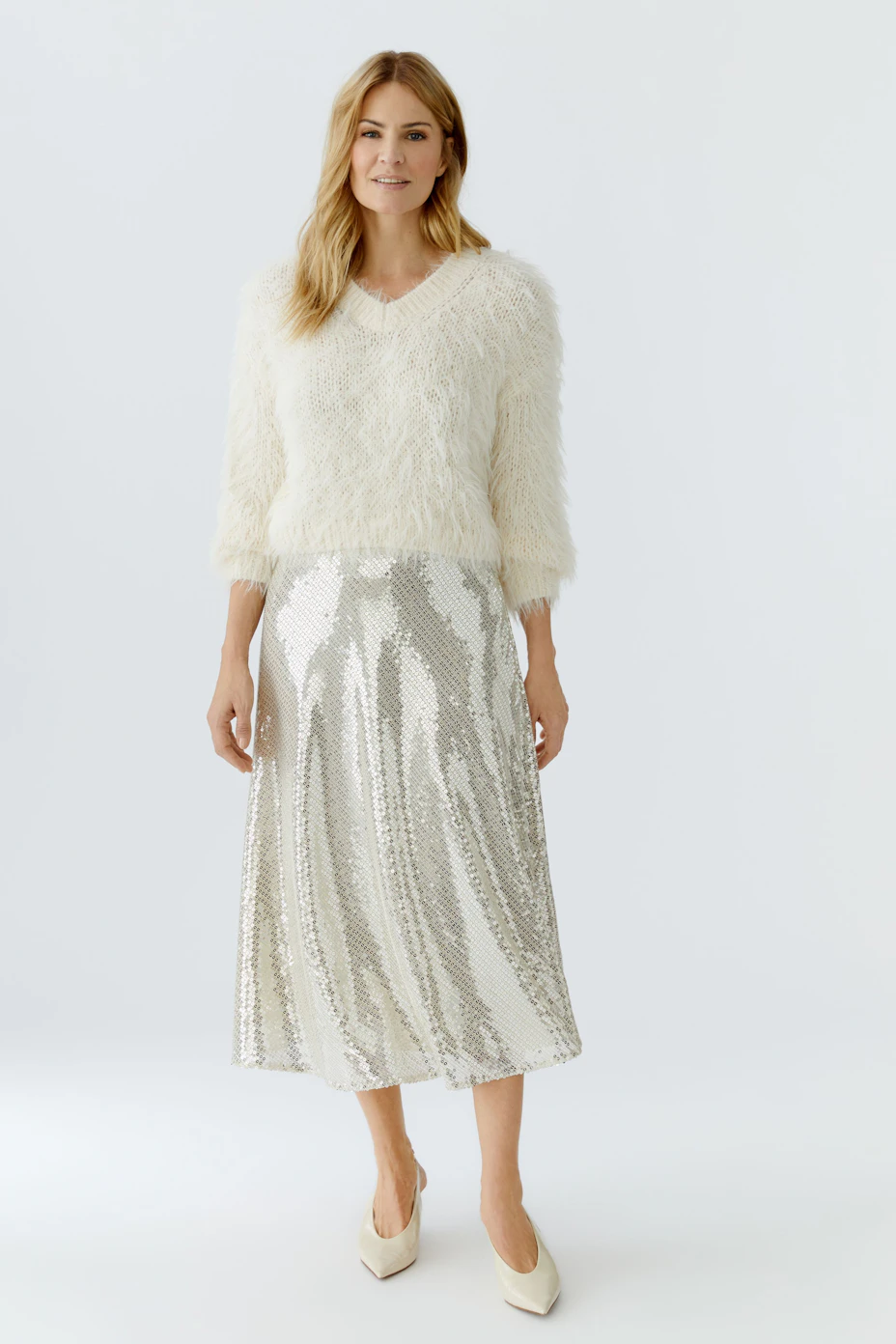 Cozy women's pullover: A fluffy white V-neck pullover with long sleeves, perfect for casual wear.