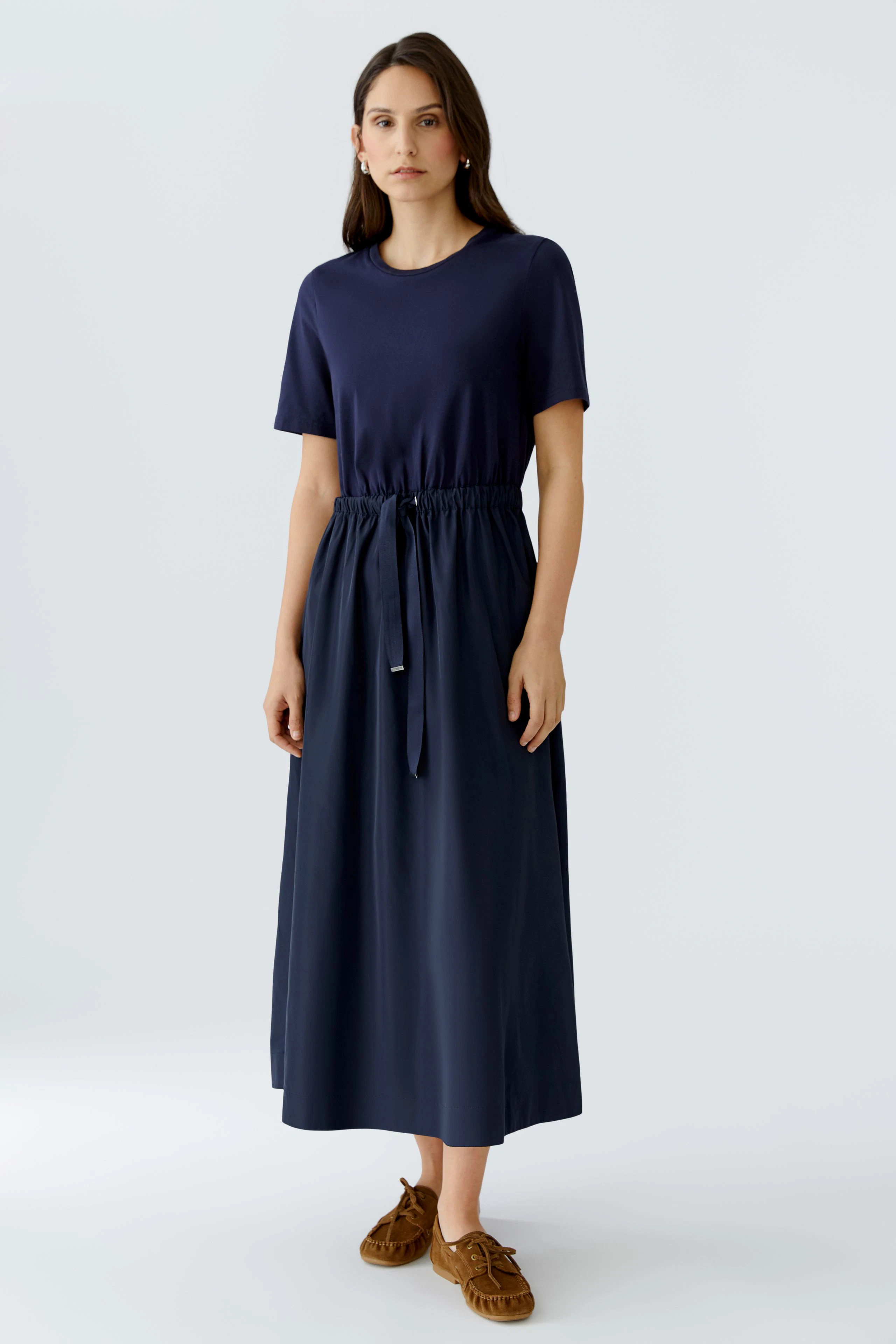 Casual maxi dress: Woman in a navy dress with a drawstring waist, perfect for everyday wear.