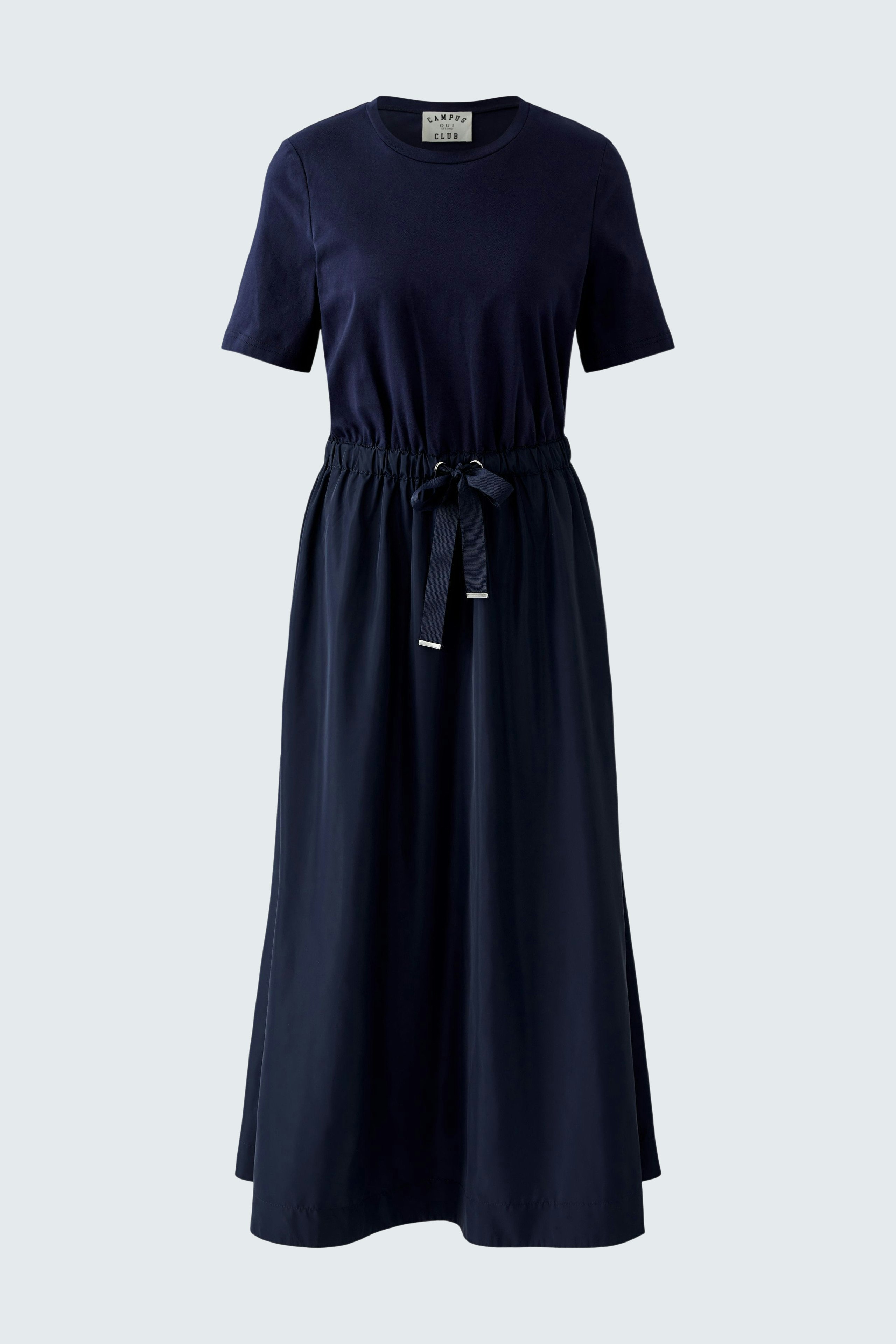 Casual maxi dress: A woman in a navy dress with a fitted top and flowing skirt, featuring a drawstring waist.
