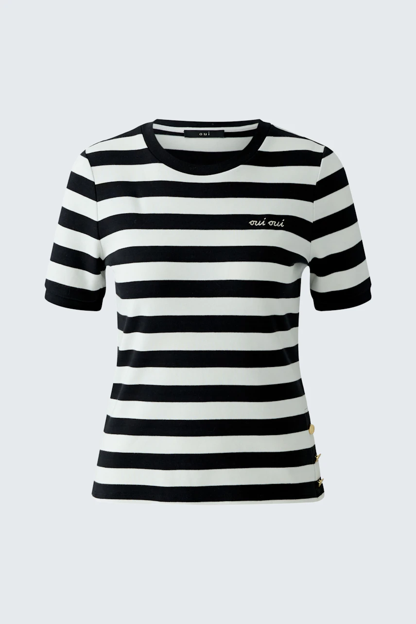 Casual women's T-shirt: A woman in a black and white striped tee with a relaxed fit.