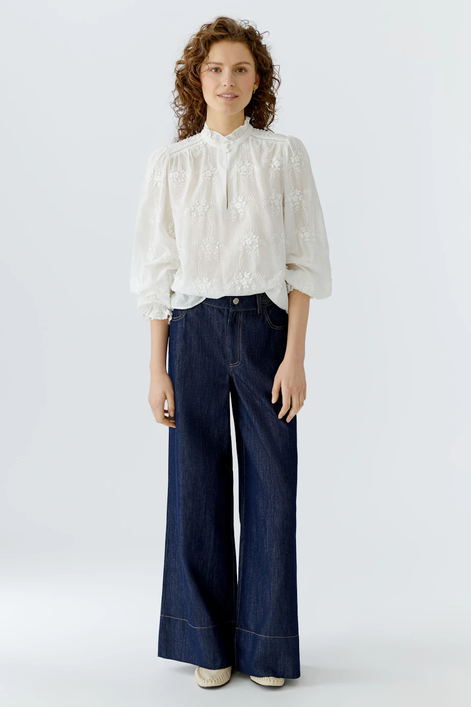 Lightweight women's blouse with floral details and a high collar, perfect for casual wear.
