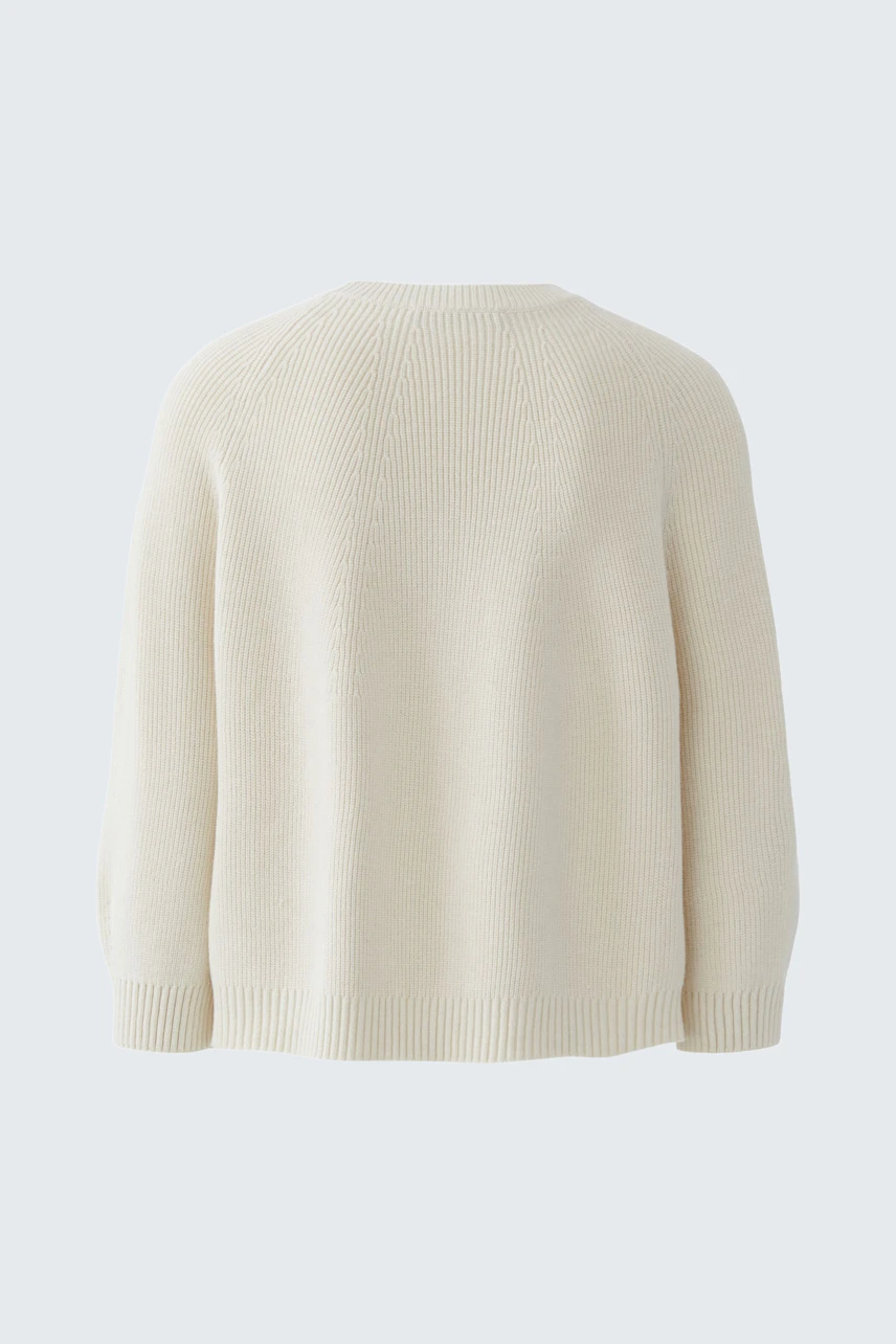 Casual women's pullover: Soft cream knit pullover with a relaxed fit and dropped shoulders.