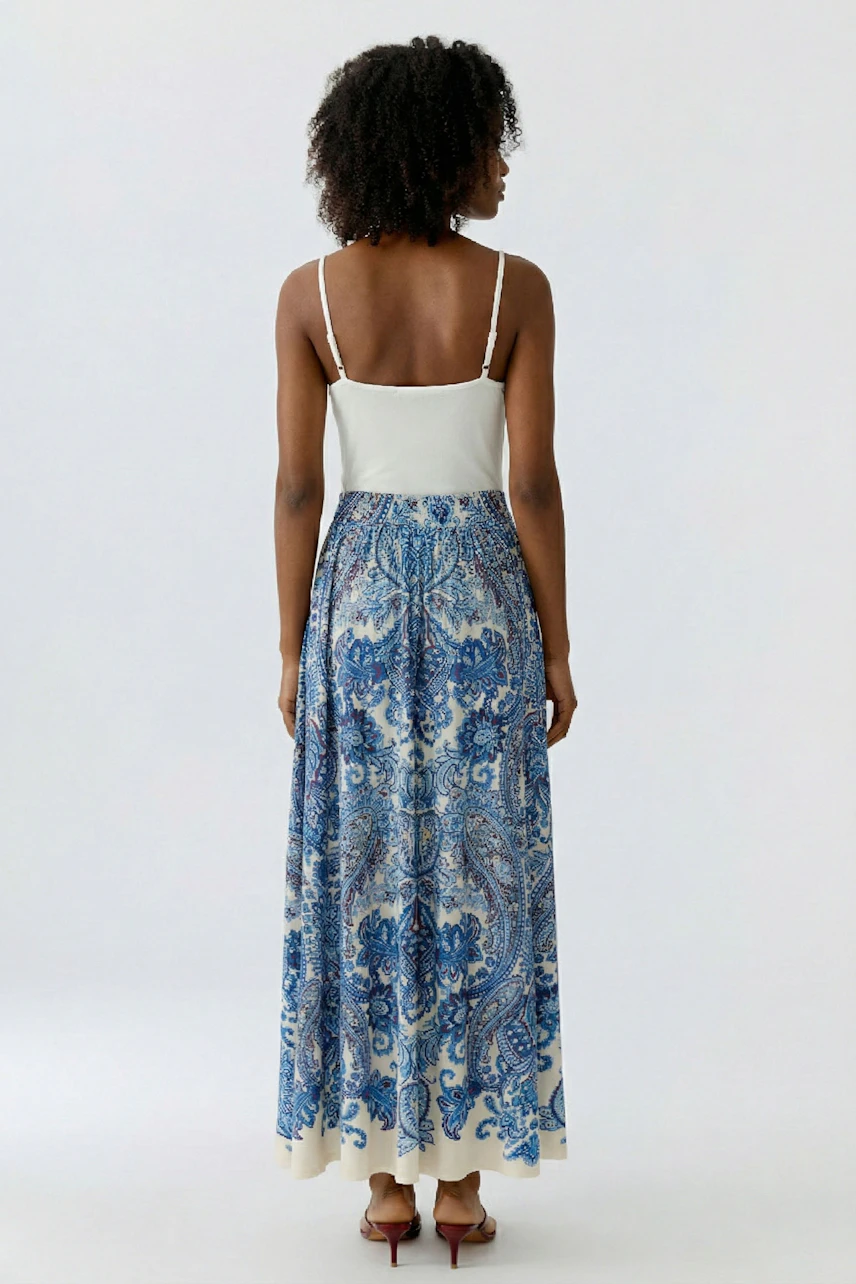 A-line skirt: Woman in a blue patterned skirt with a flowy design, showcasing a relaxed style.