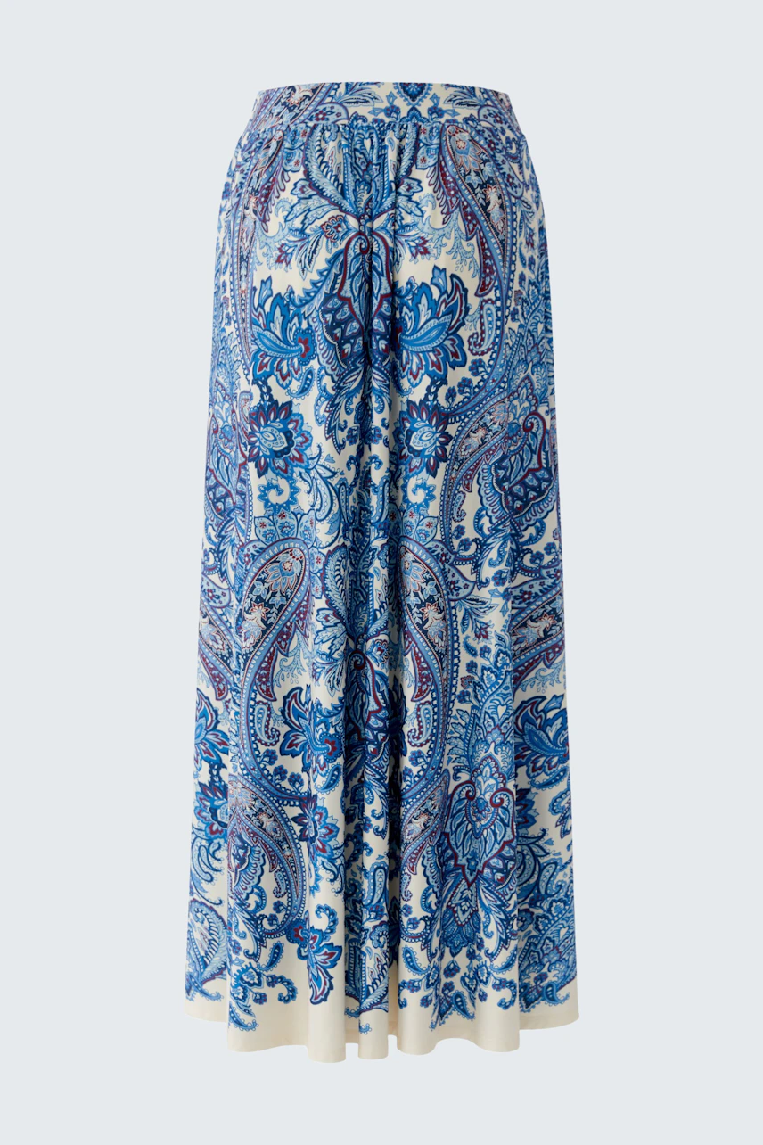 A-line skirt: A woman in a blue patterned skirt with a flowing design, perfect for casual wear.
