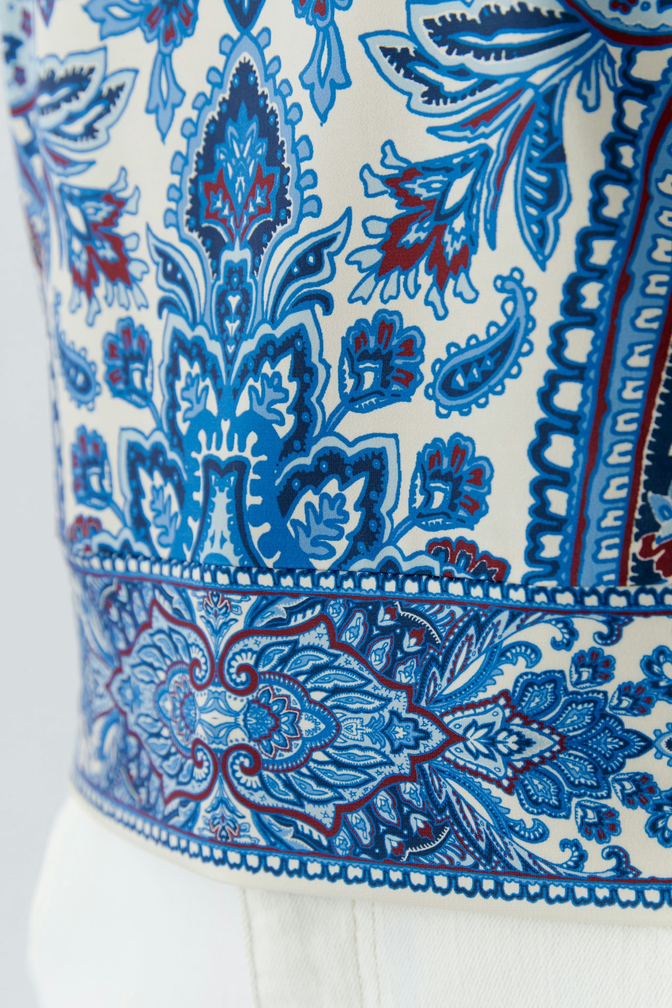 Stylish women's blouse shirt with a vibrant blue and red floral pattern, perfect for casual wear.