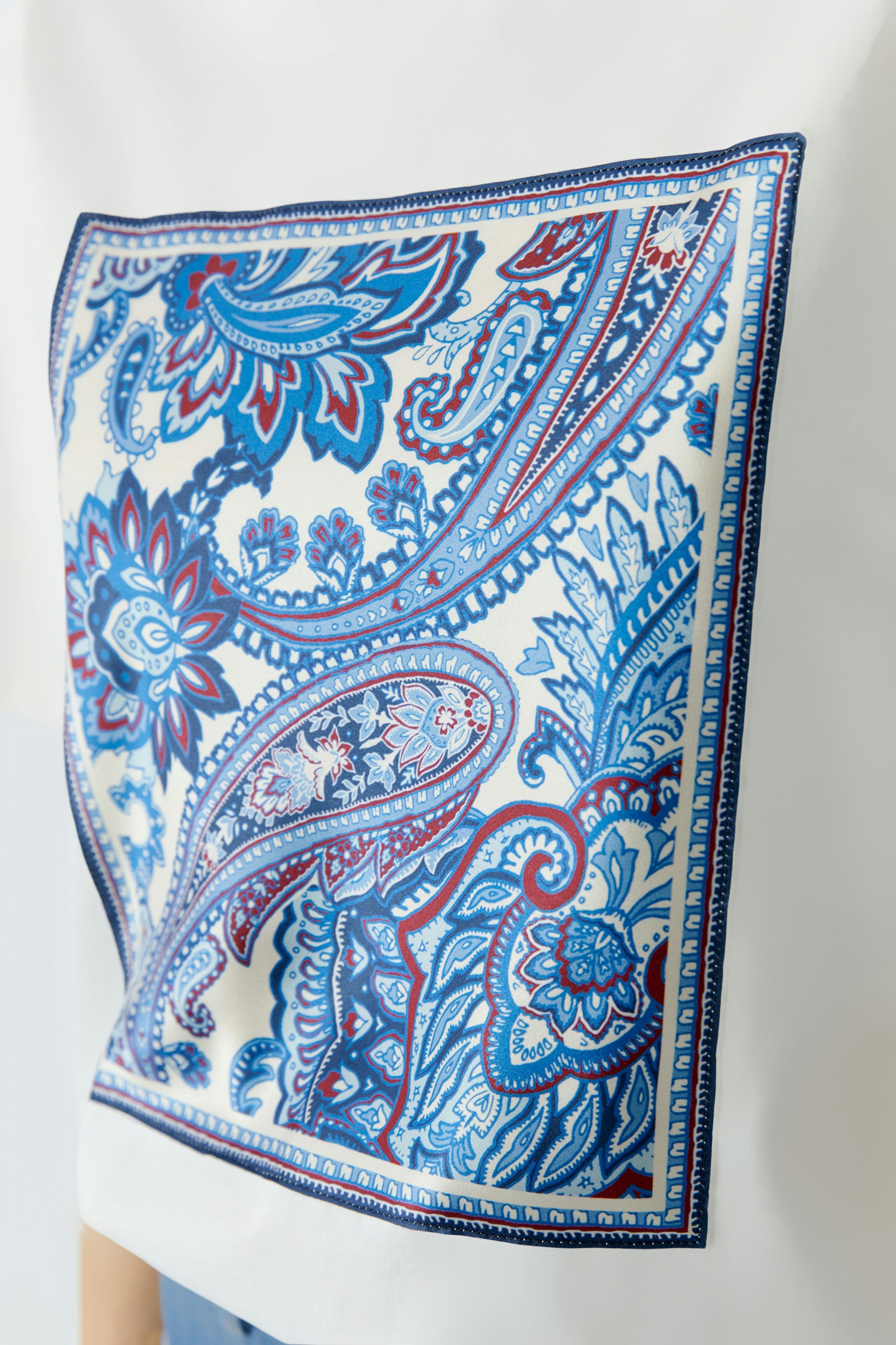 Stylish women's T-shirt featuring a vibrant paisley print, perfect for casual wear.