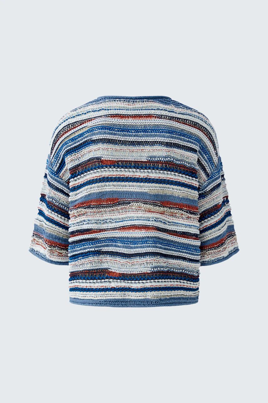 Casual women's pullover: A woman in a striped pullover with blue and red tones, showcasing a relaxed fit.