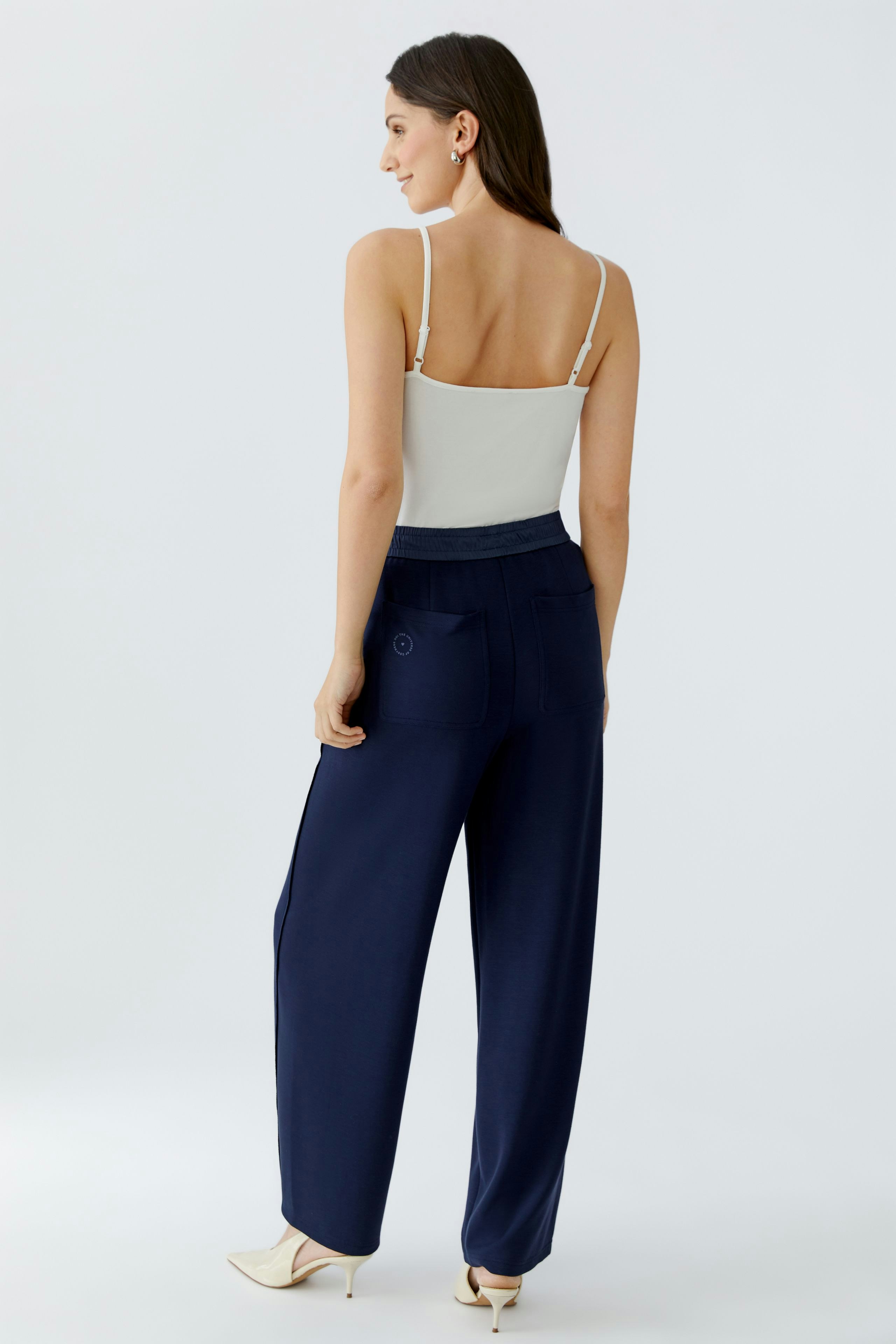 Casual women's sweatpants: A woman in navy sweatpants with a relaxed fit and back pockets.
